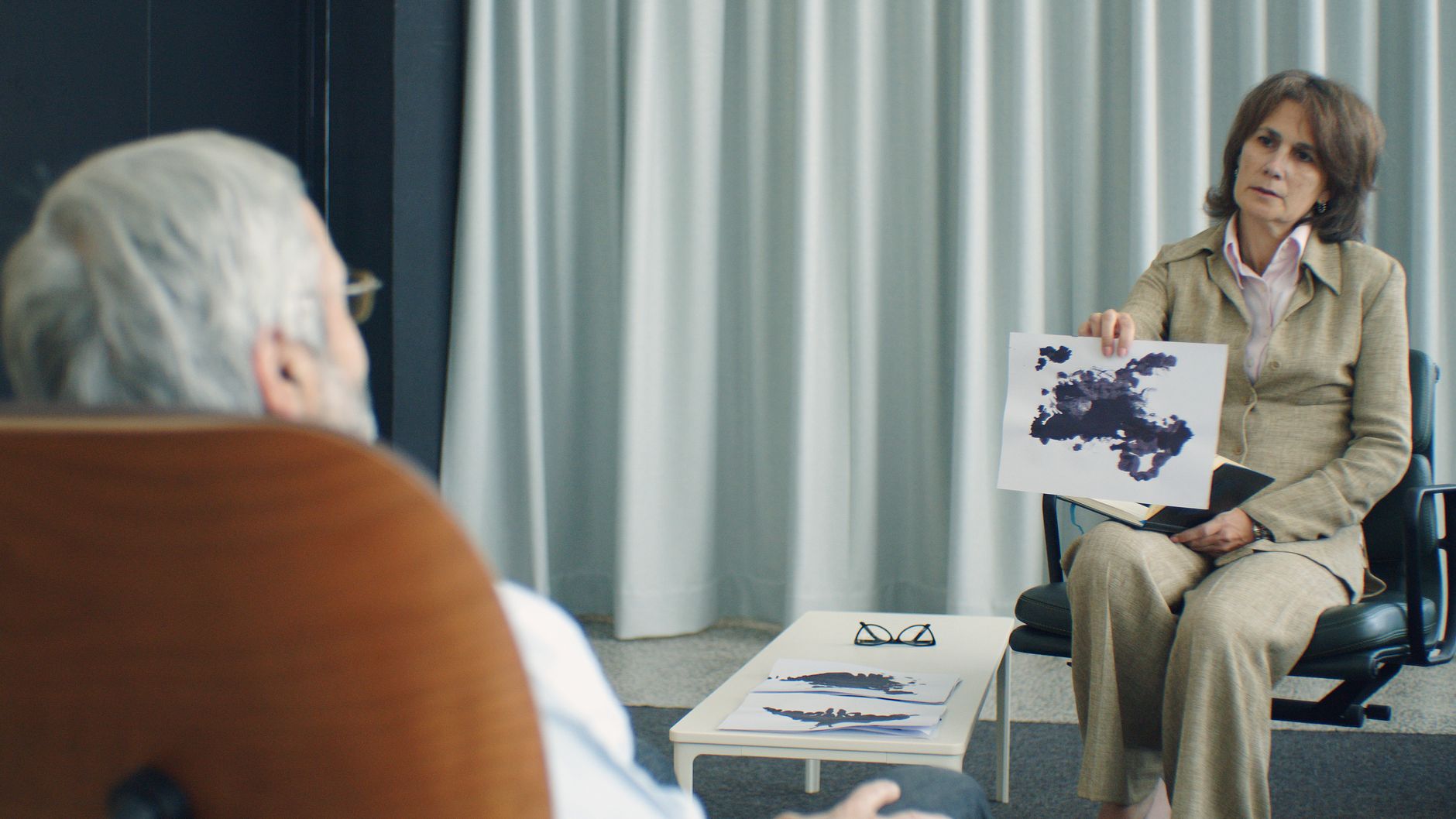 A therapist and patient in a psychotherapy session, discussing inkblot test results — UPI Study