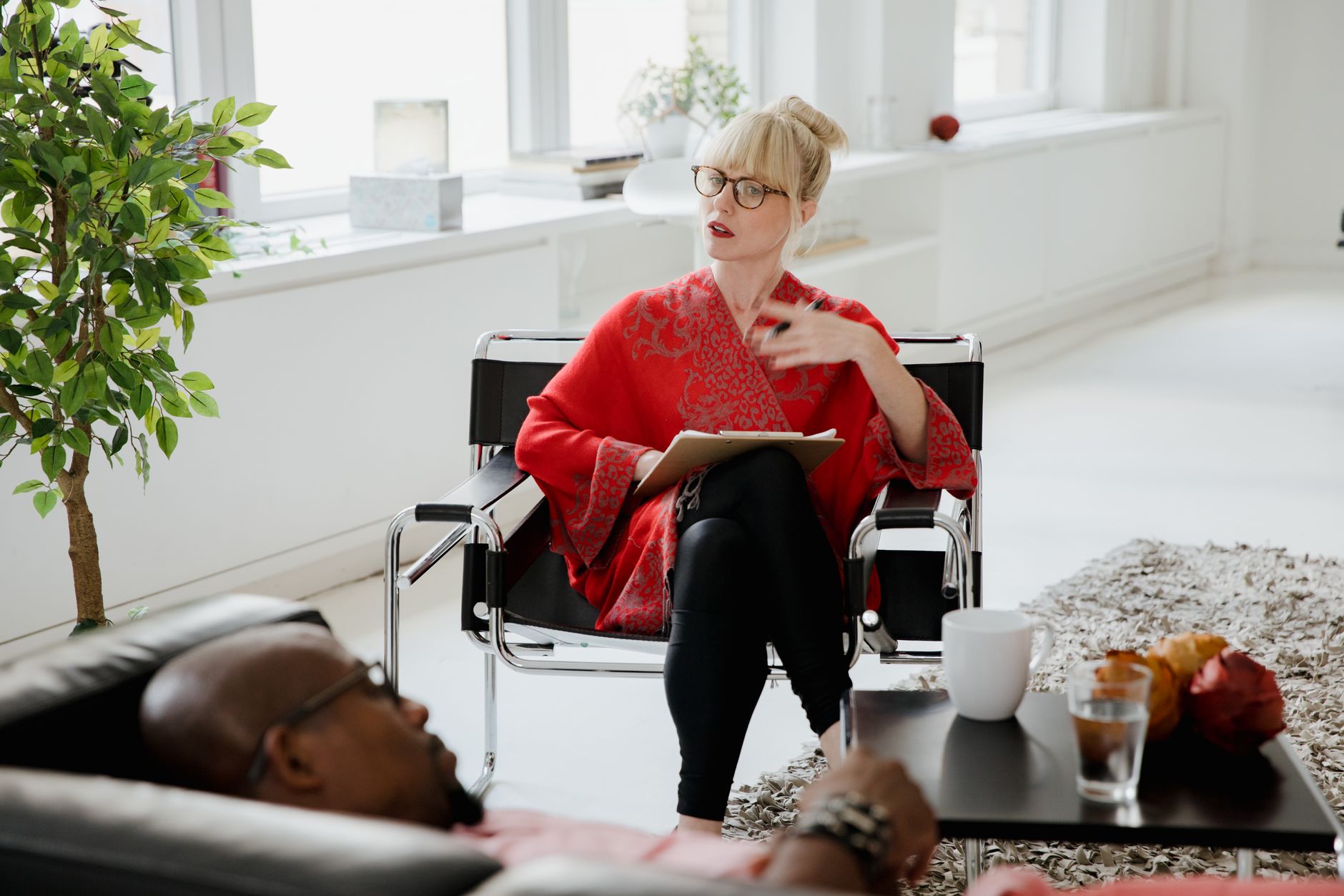 A therapist consults with a patient in a bright, modern office setting — UPI Study