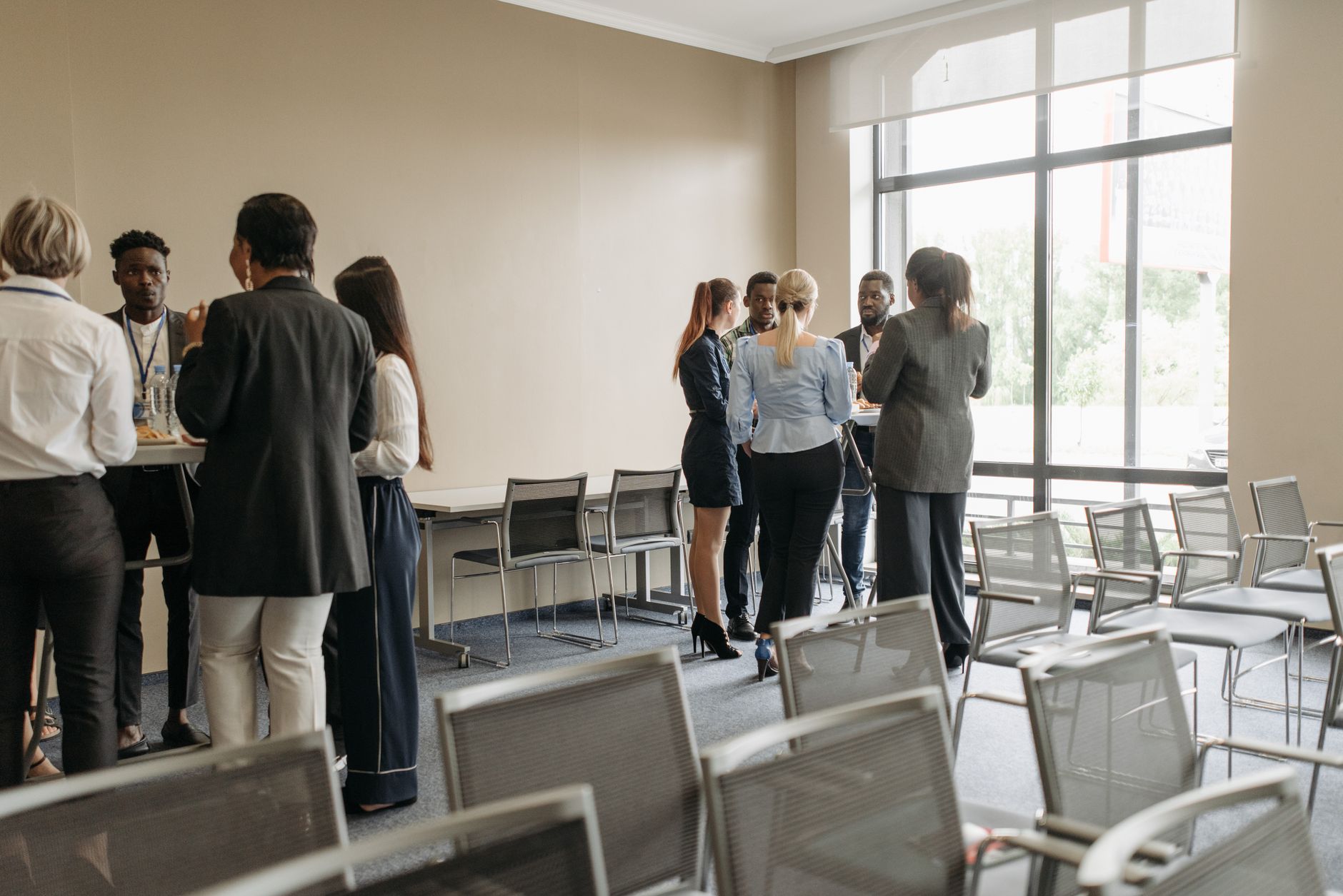 Professionals engaging in a casual networking session during a business conference — UPI Study