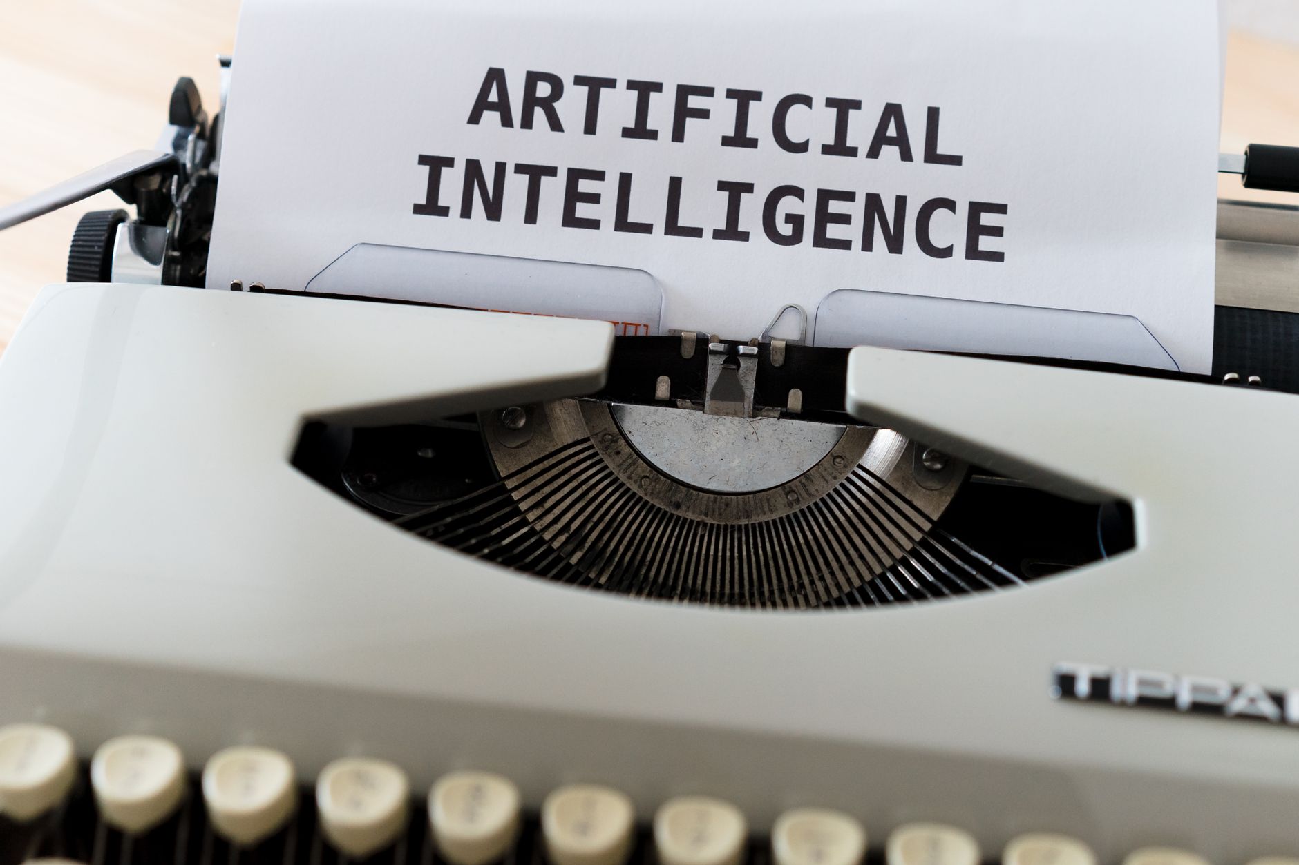 A close-up of a typewriter showcasing 'ARTIFICIAL INTELLIGENCE' on paper — UPI Study