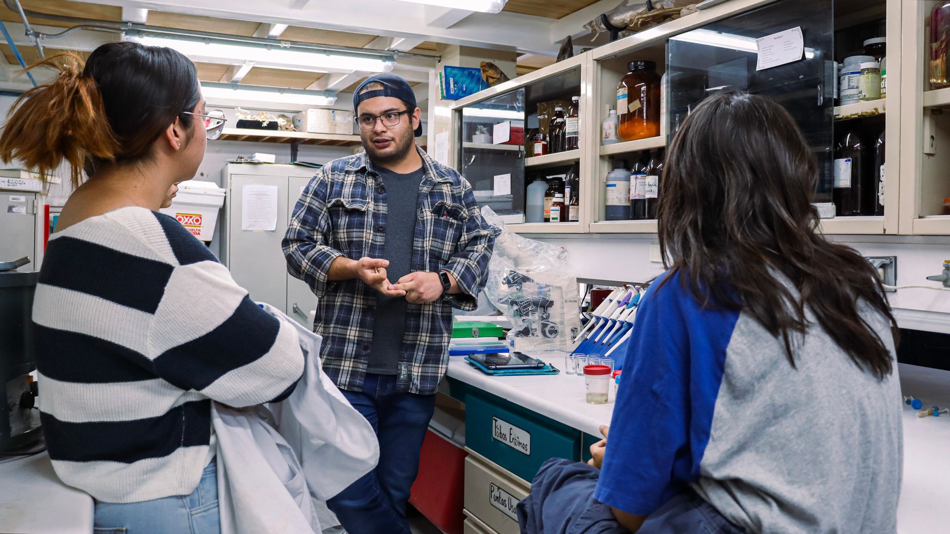 Group of students engaged in discussion inside a chemistry laboratory — UPI Study