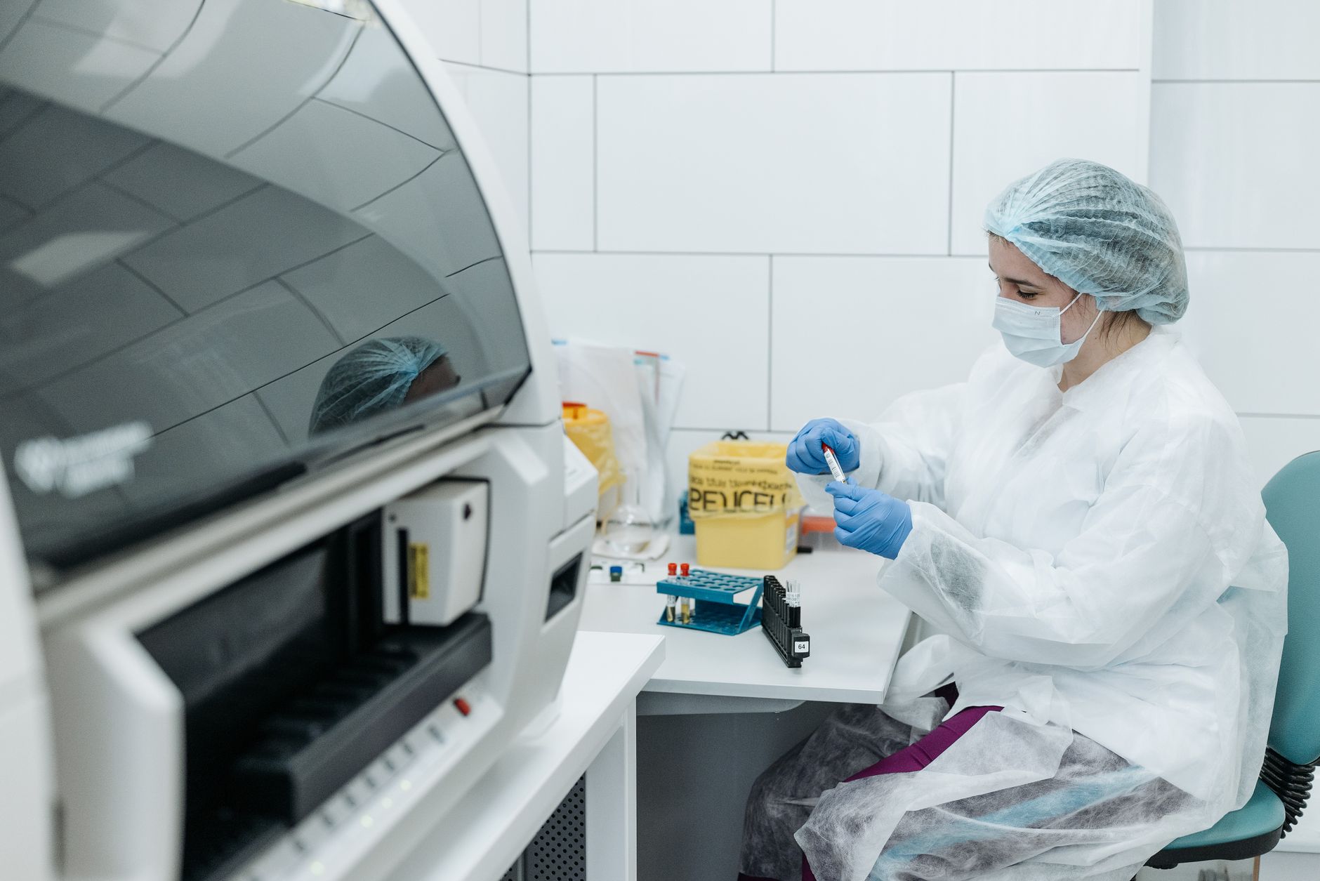 Scientist in protective gear examining samples in a medical lab setting, focusing on research — UPI Study