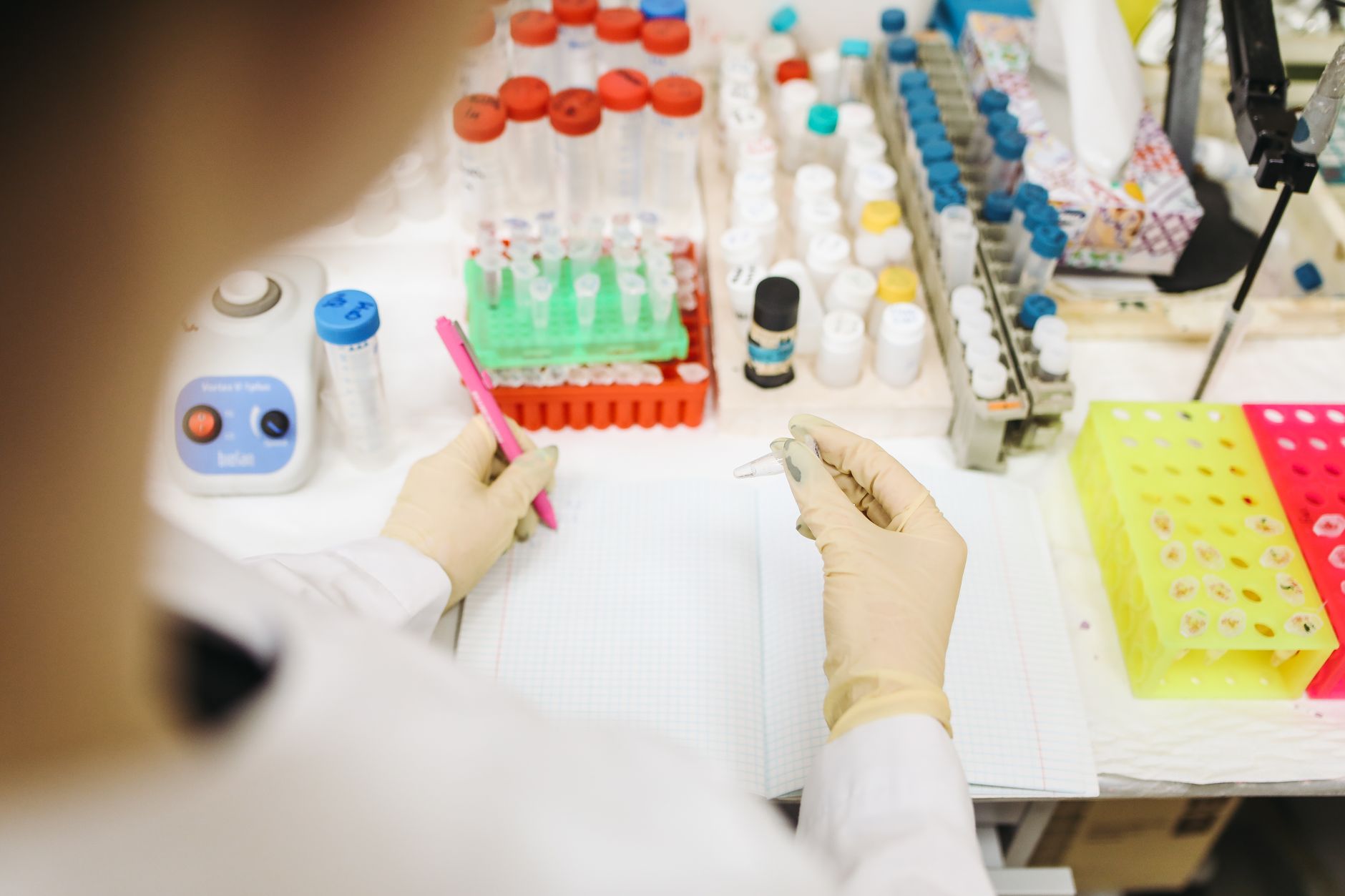 Scientist analyzing samples in a lab with various test tubes and equipment — UPI Study