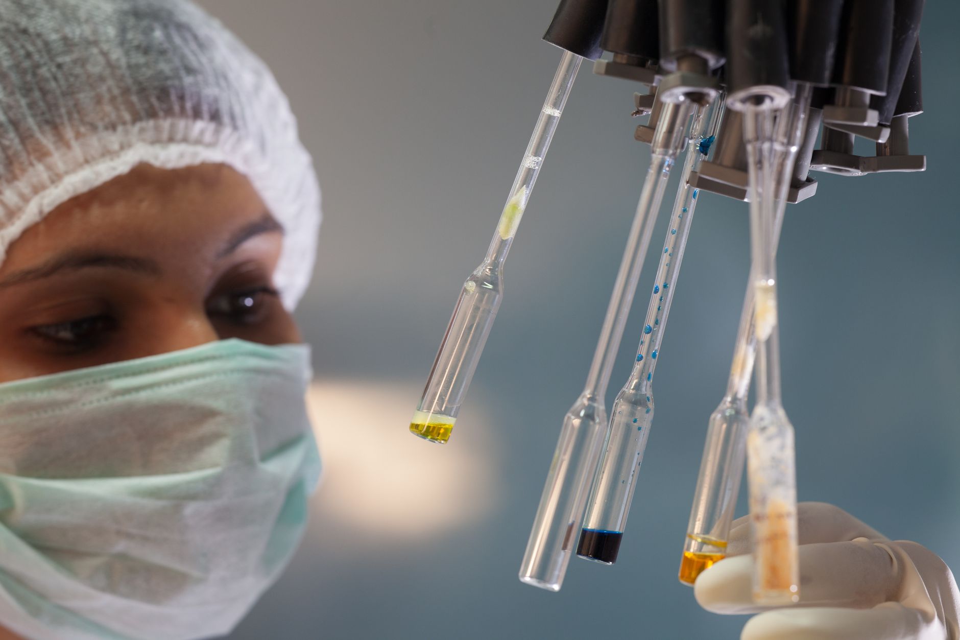 Woman scientist in lab handling test tubes with precision and focus — UPI Study