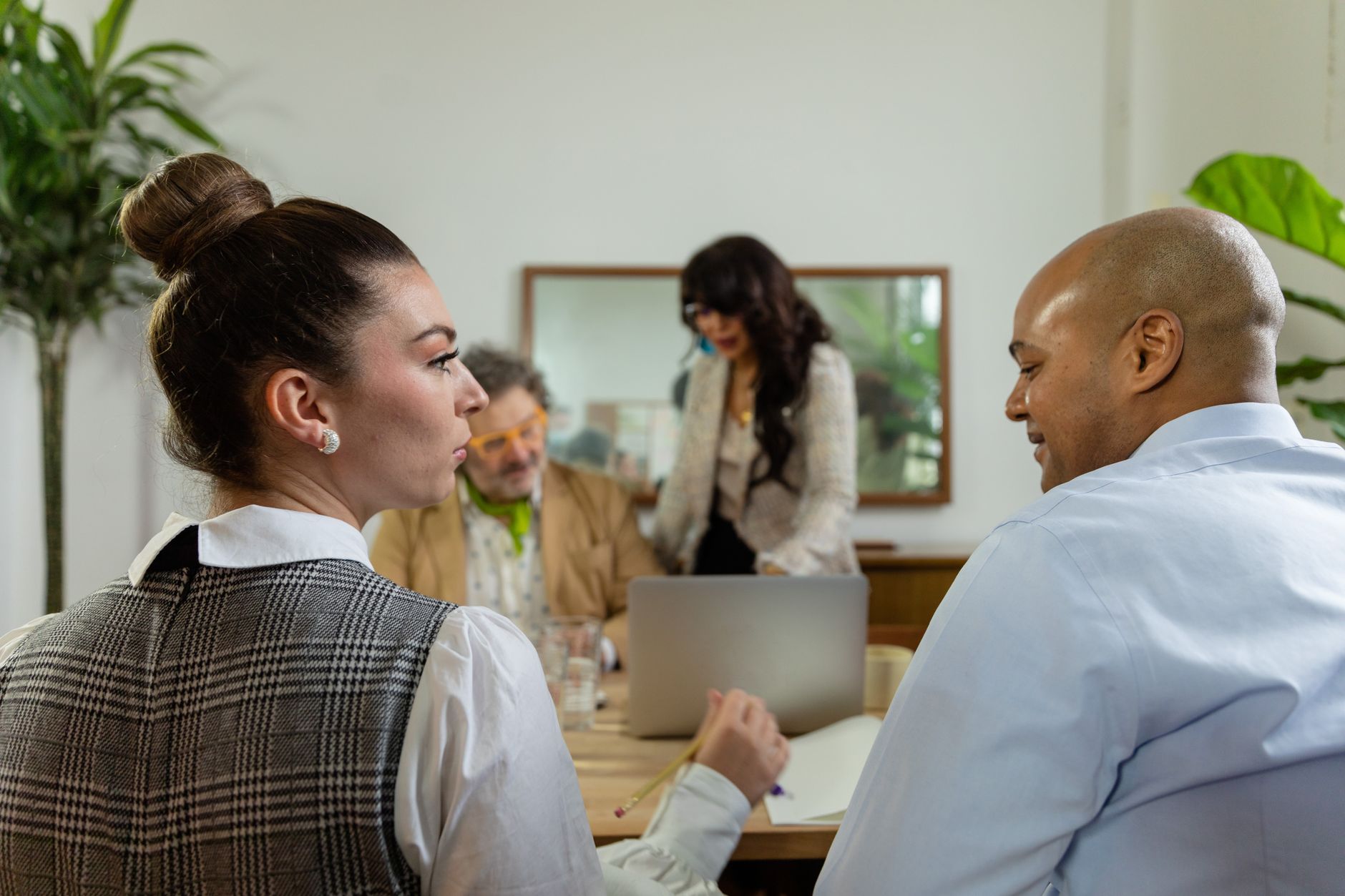 Engaged office team in business discussion around a laptop, fostering collaboration — UPI Study