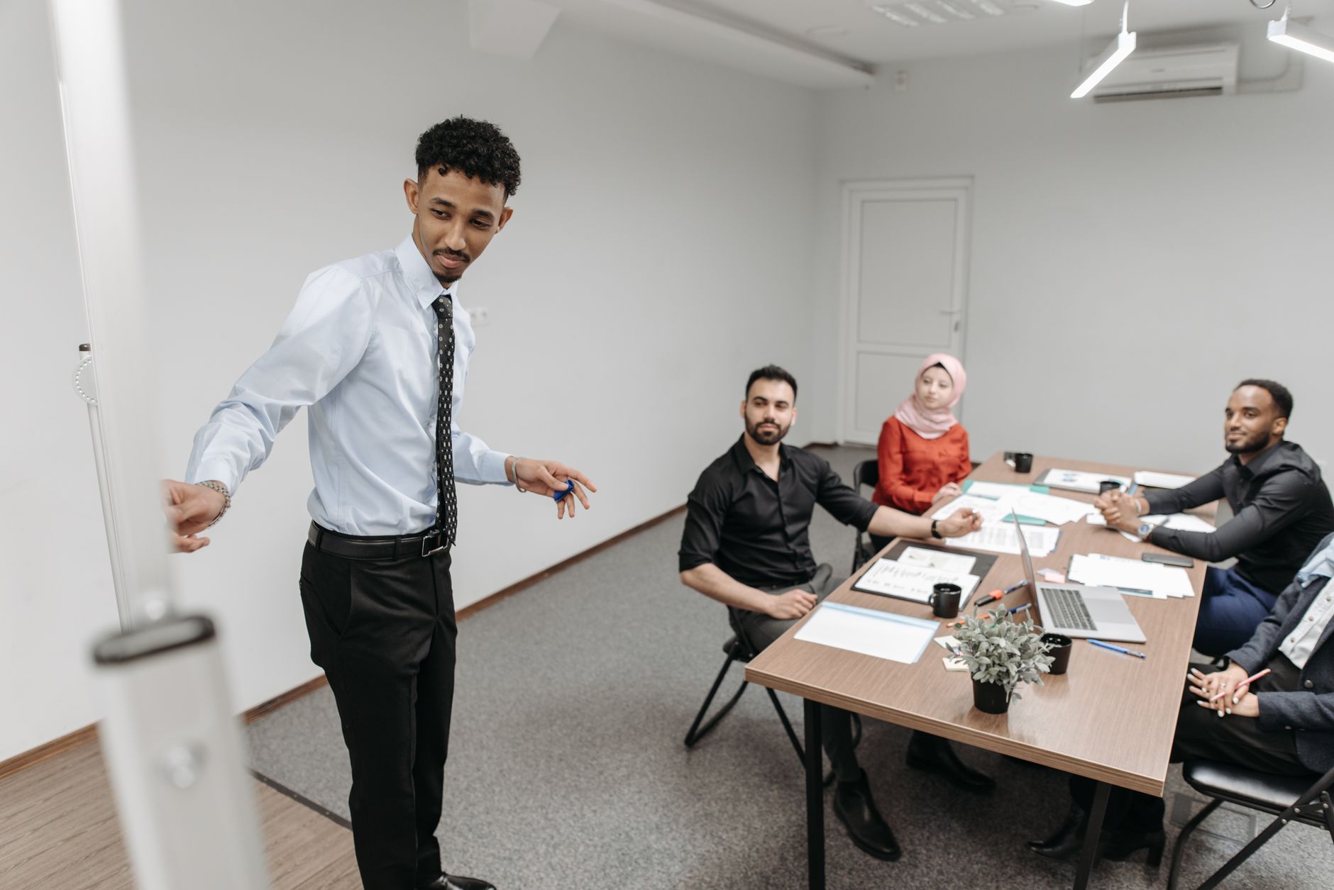 A diverse team collaborates in a modern office setting, showcasing teamwork and communication — UPI Study