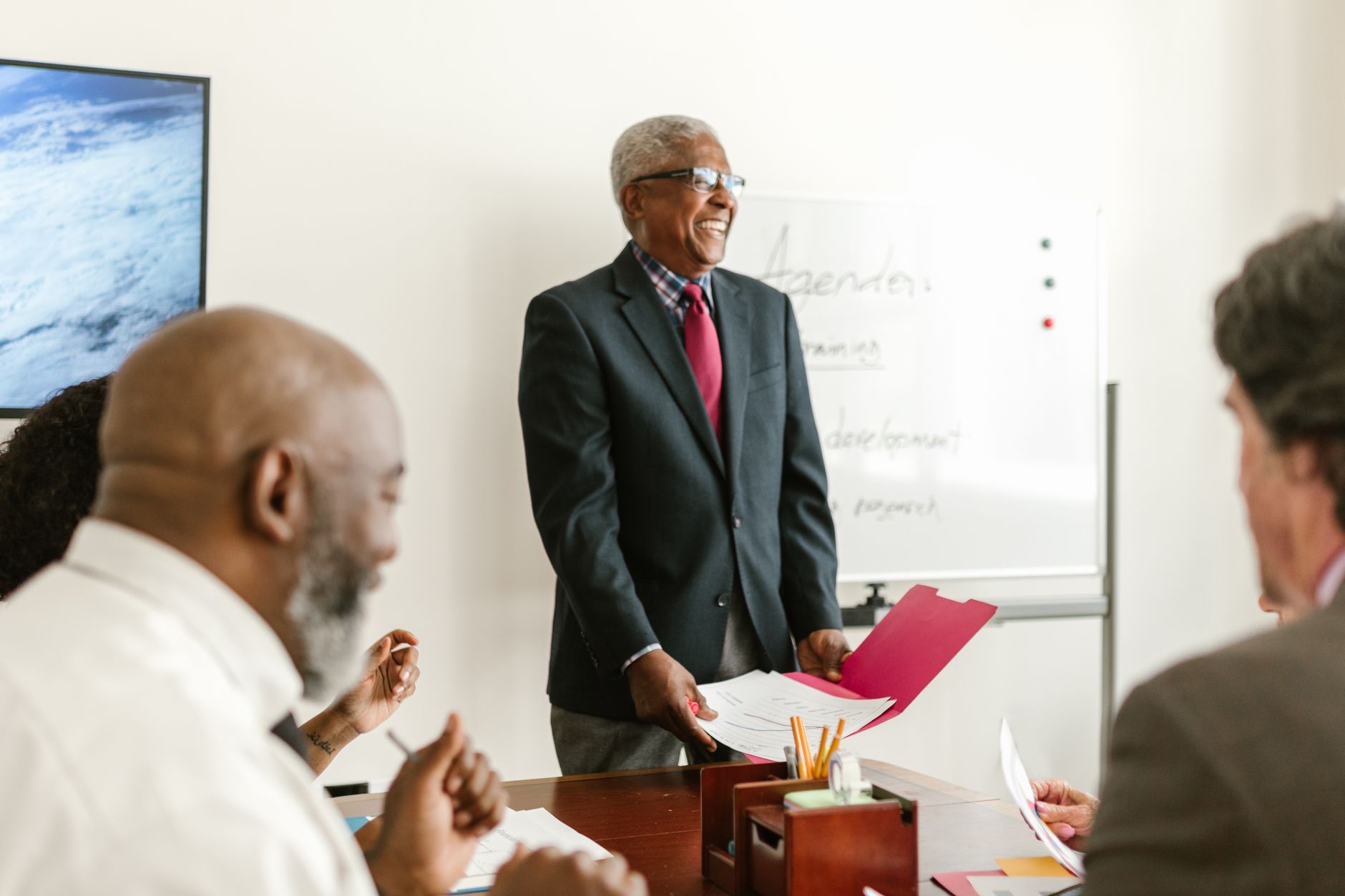 Professional meeting scene showcasing discussions and presentations in an office setting — UPI Study
