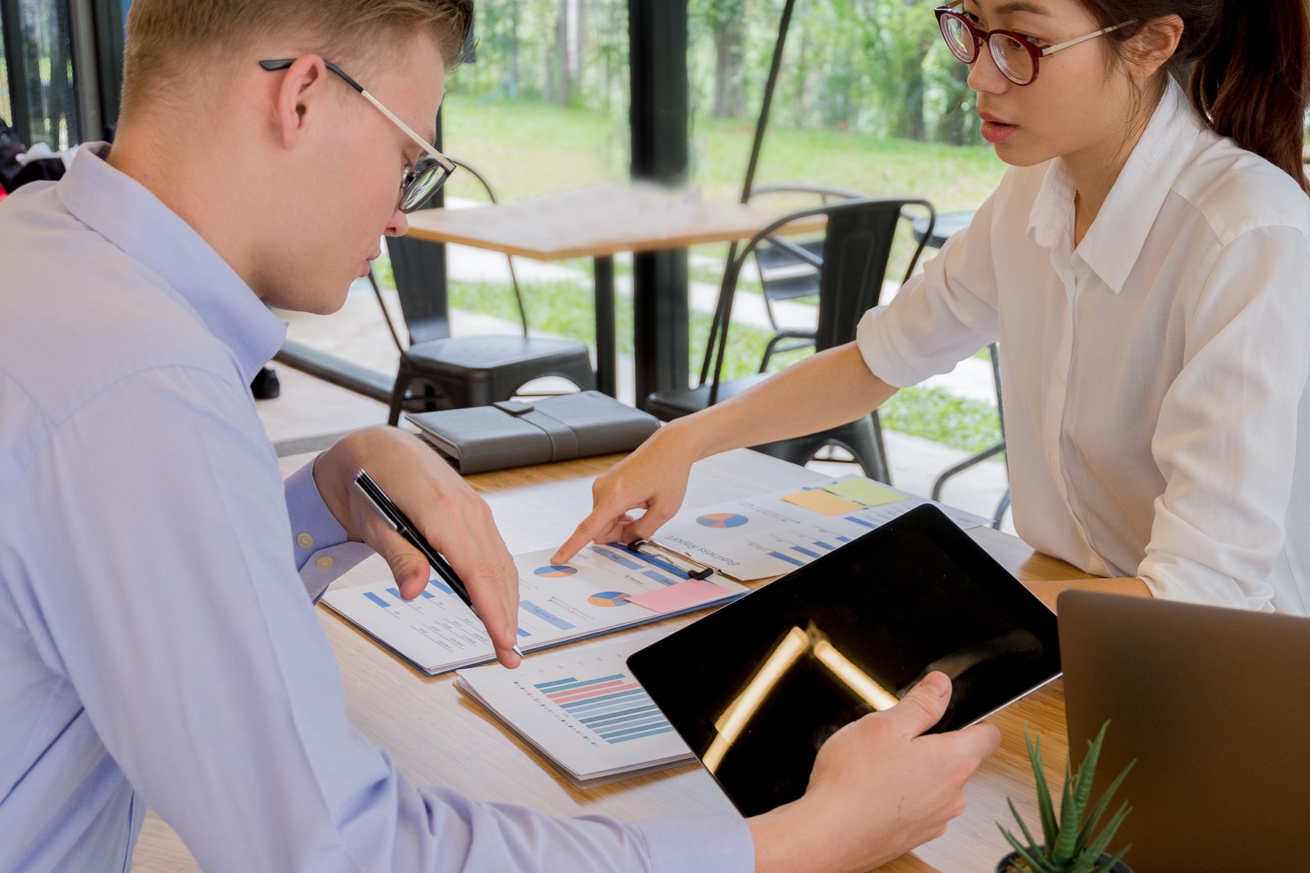 Team collaboration over financial documents in a modern office setting — UPI Study