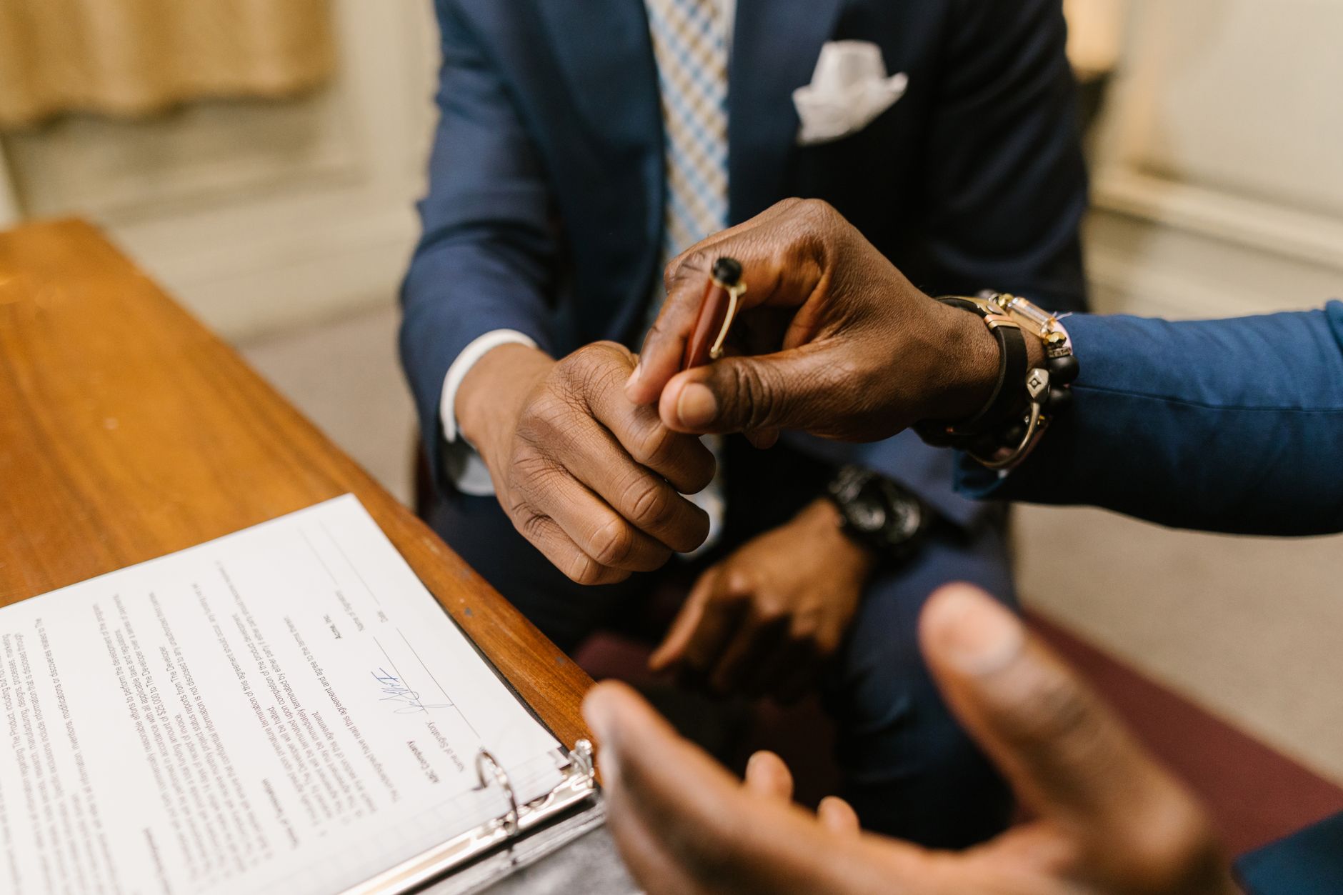 Two businessmen in suits finalize a contract, highlighting teamwork and agreement — UPI Study