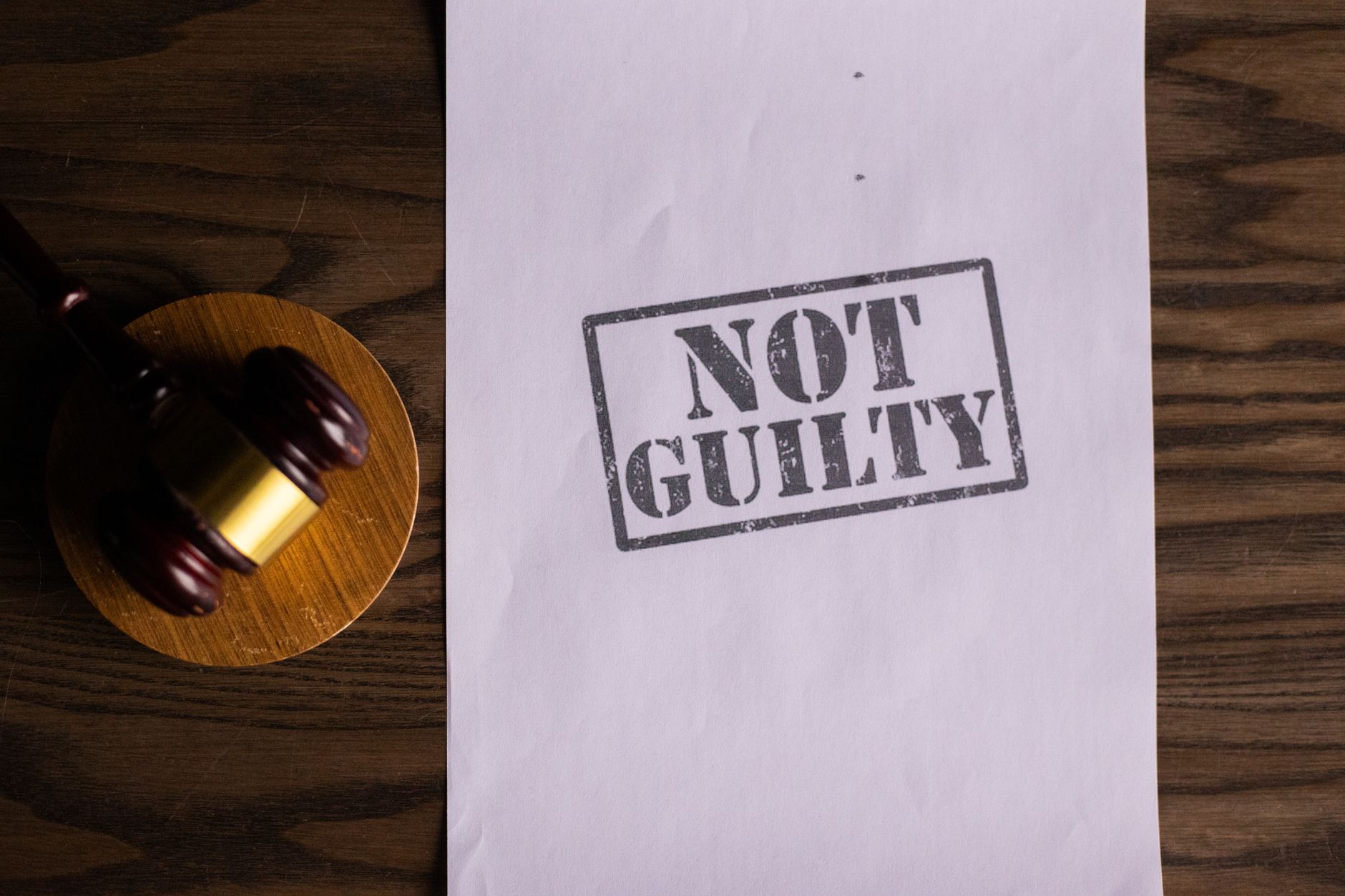 A courtroom document labeled 'Not Guilty' beside a gavel symbolizes justice — UPI Study