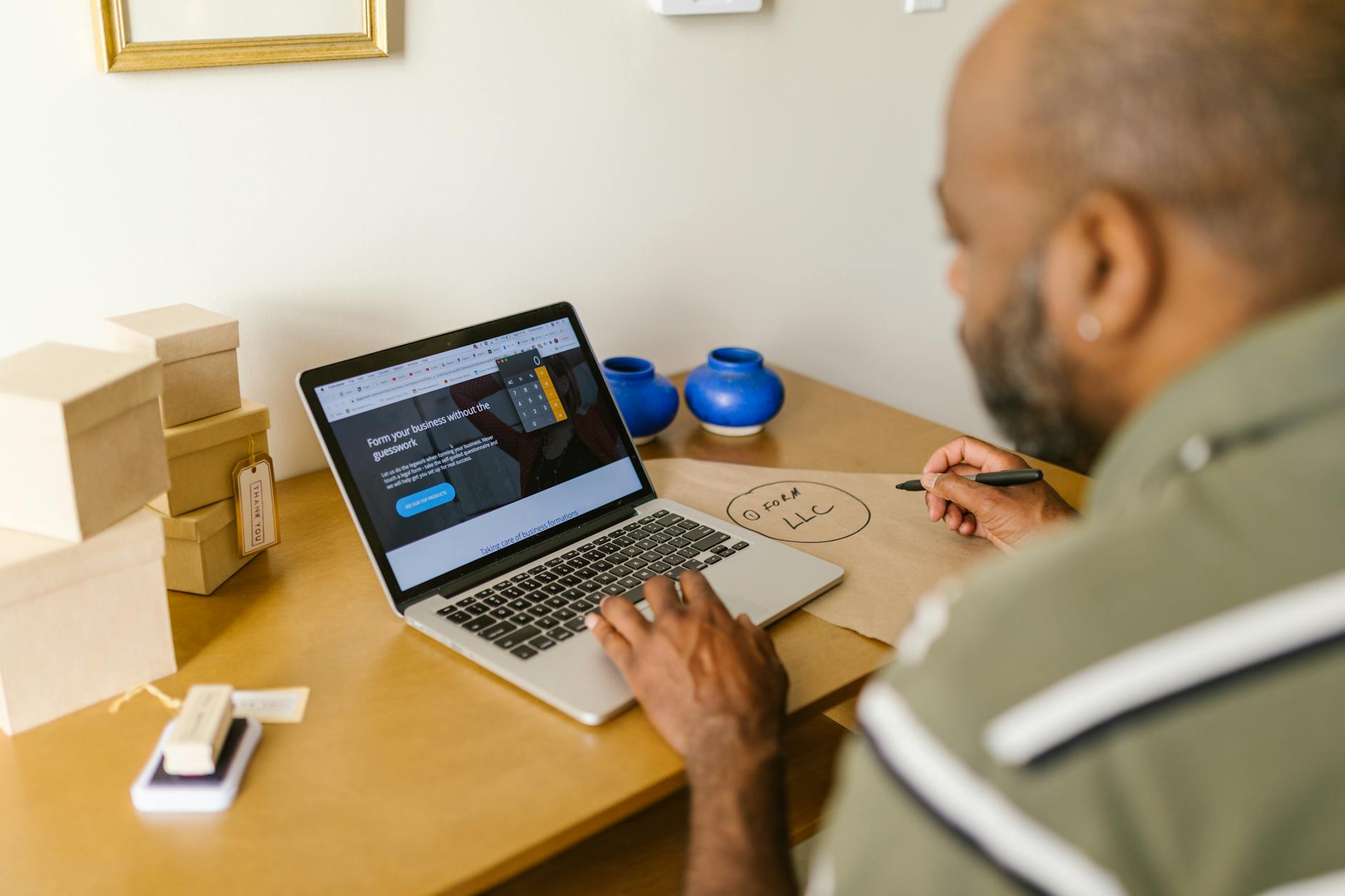 Entrepreneur at a desk using a laptop for business planning. Ideal for tech and startup themes — UPI Study