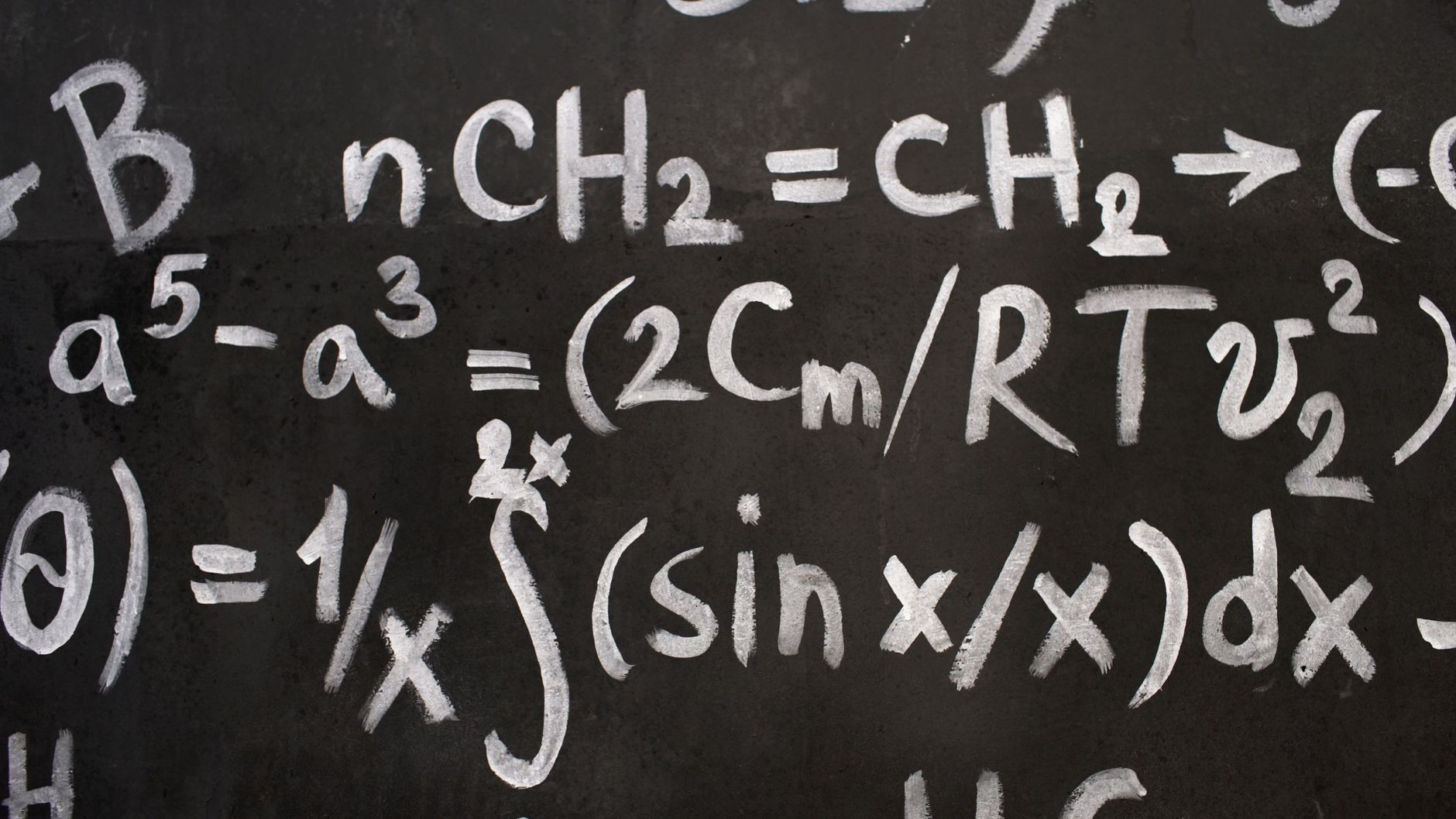 Close-up of complex equations on a chalkboard, showcasing chemistry and math symbols — UPI Study