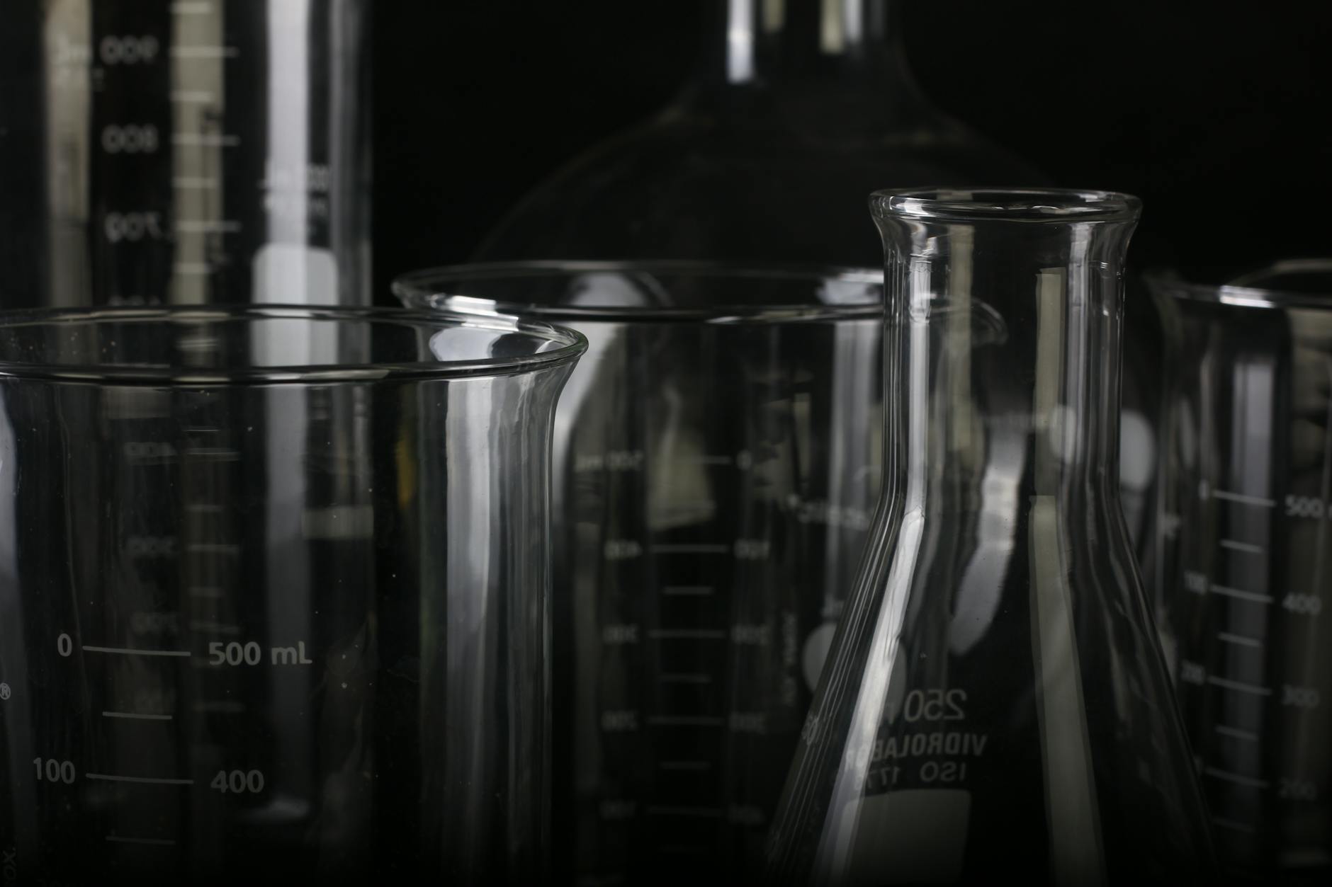 A detailed close-up of various transparent laboratory glassware used in scientific experiments — UPI Study