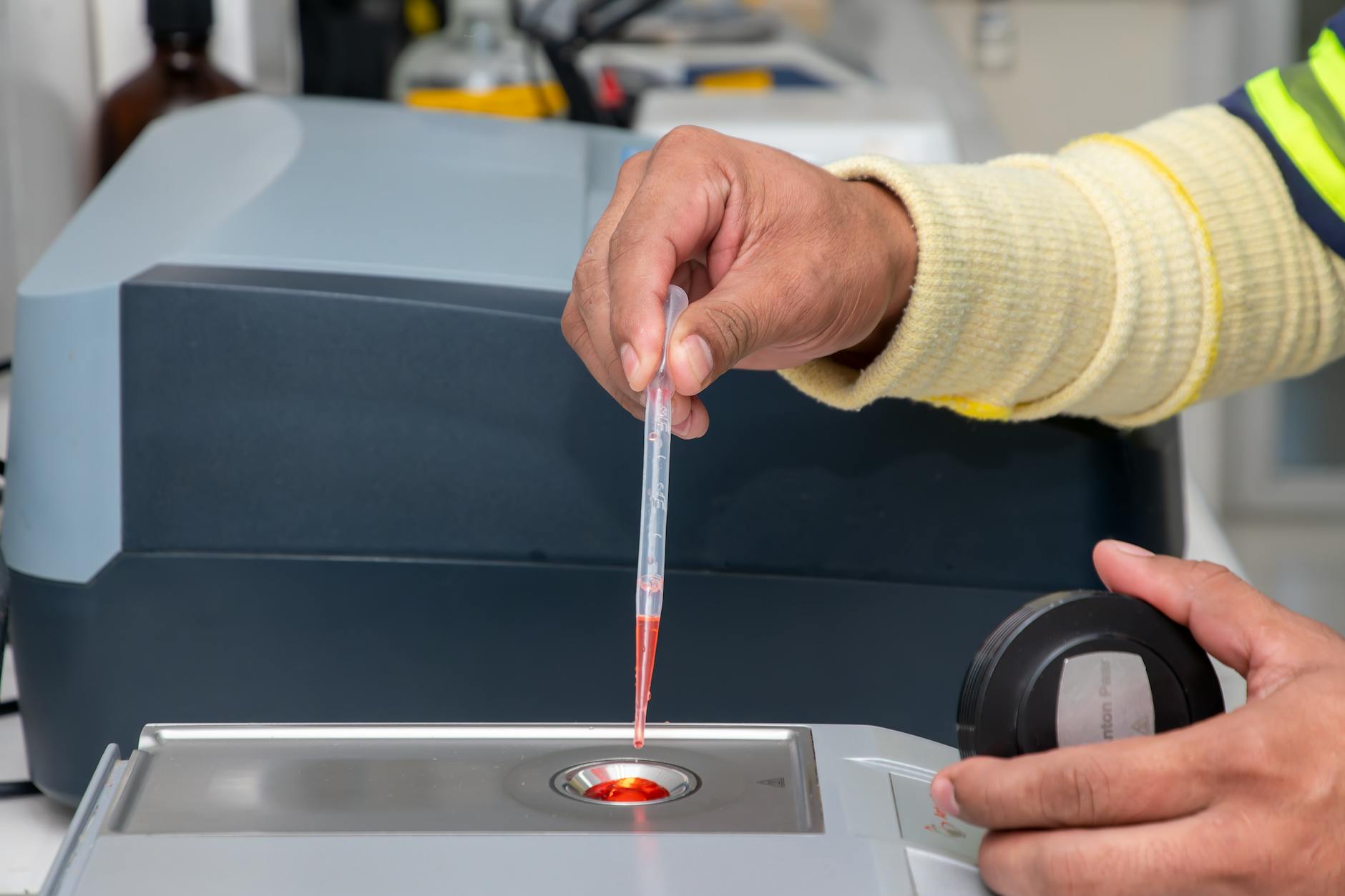 Close-up of a laboratory technician using a pipette for precise measurement in a modern lab — UPI Study