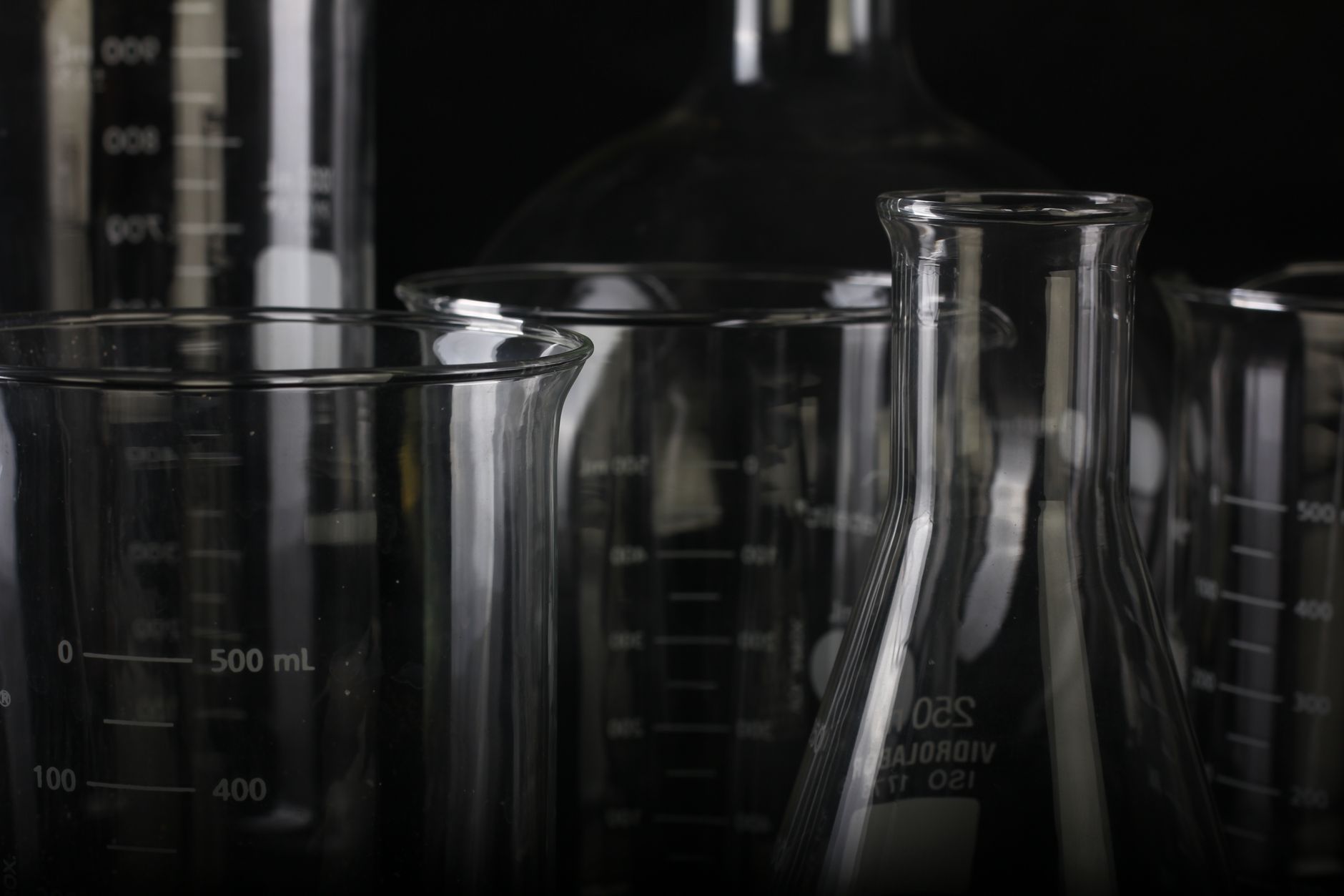 A detailed close-up of various transparent laboratory glassware used in scientific experiments — UPI Study