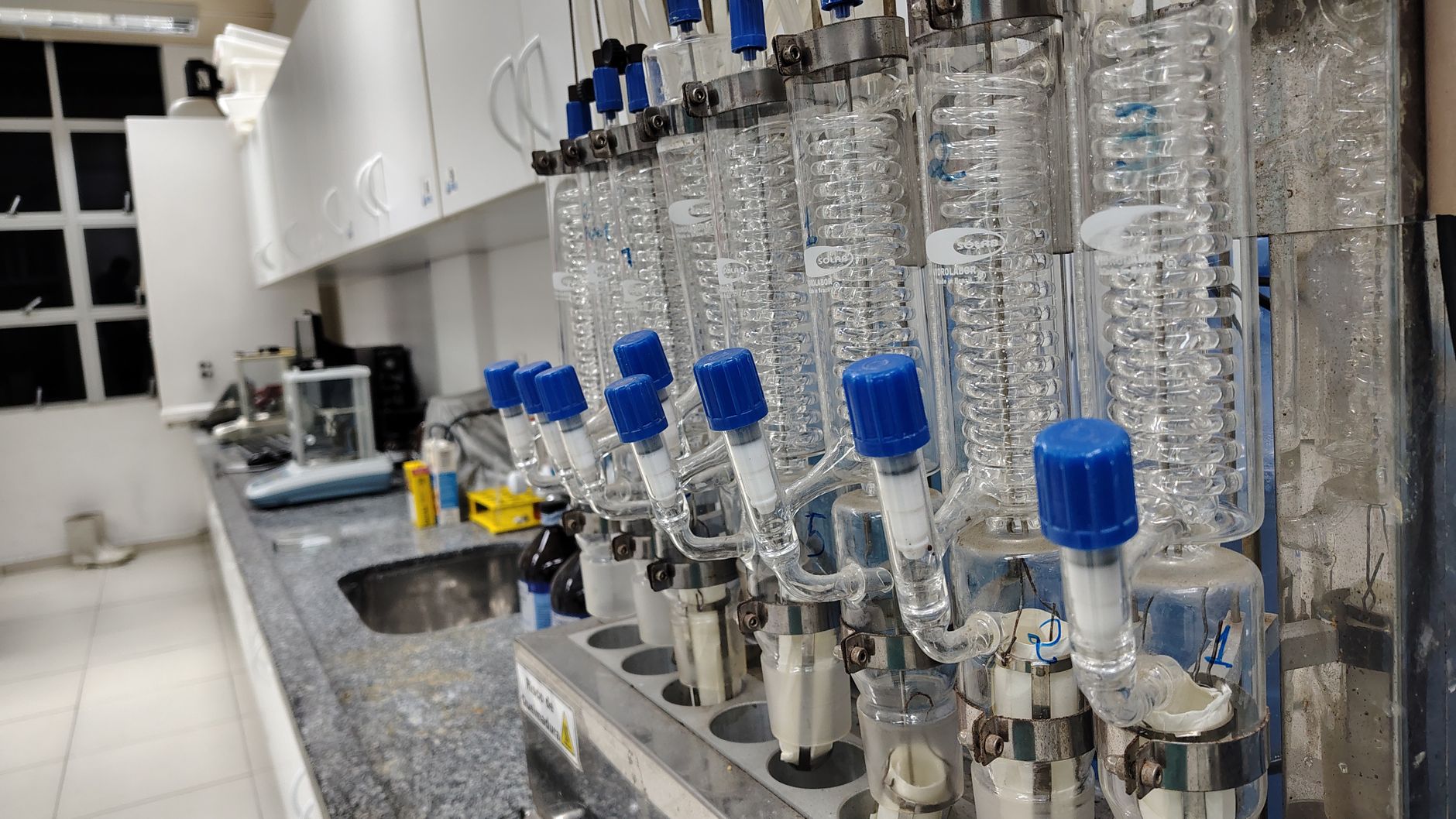 Image of a laboratory setup with glass condensers and lab equipment on the countertop — UPI Study