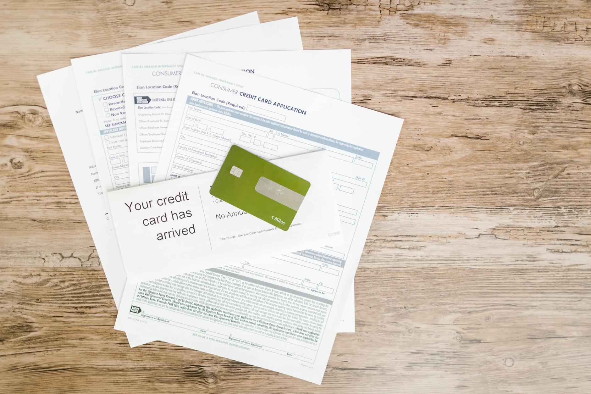 Top view of credit card and application documents on wooden surface — UPI Study