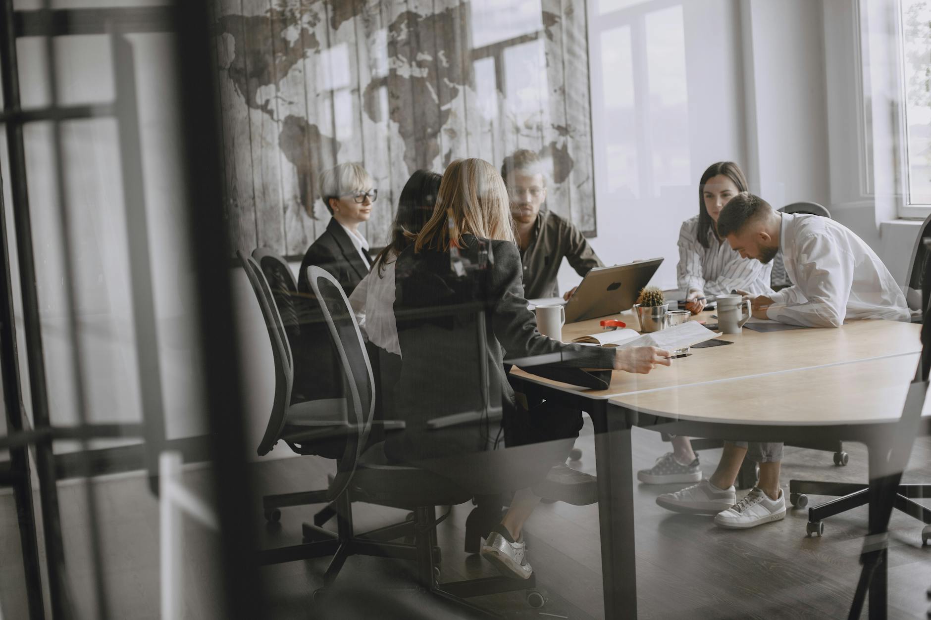 Professionals in a meeting room engaged in a collaborative business discussion — UPI Study