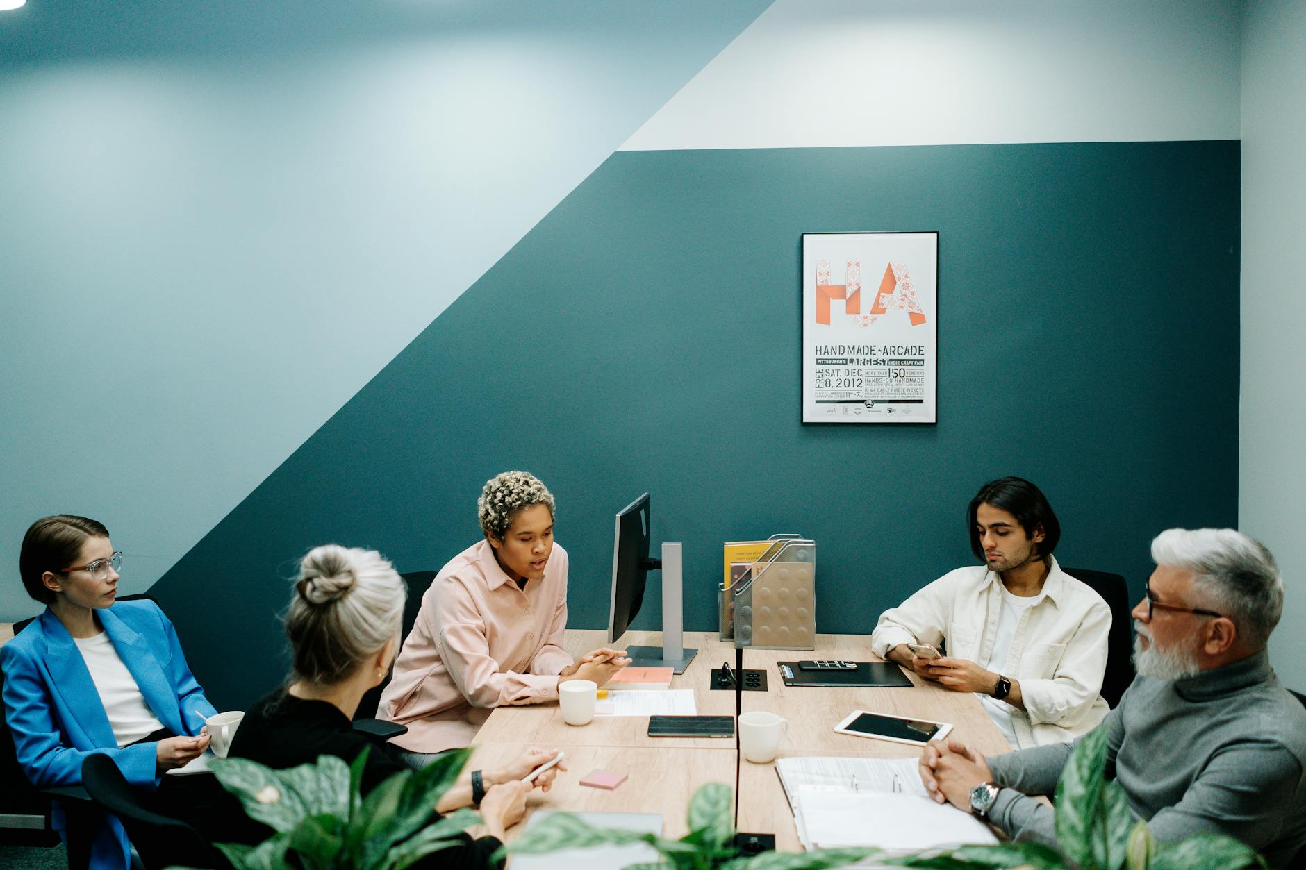 A group of diverse professionals engaged in a team meeting in a contemporary office environment — UPI Study