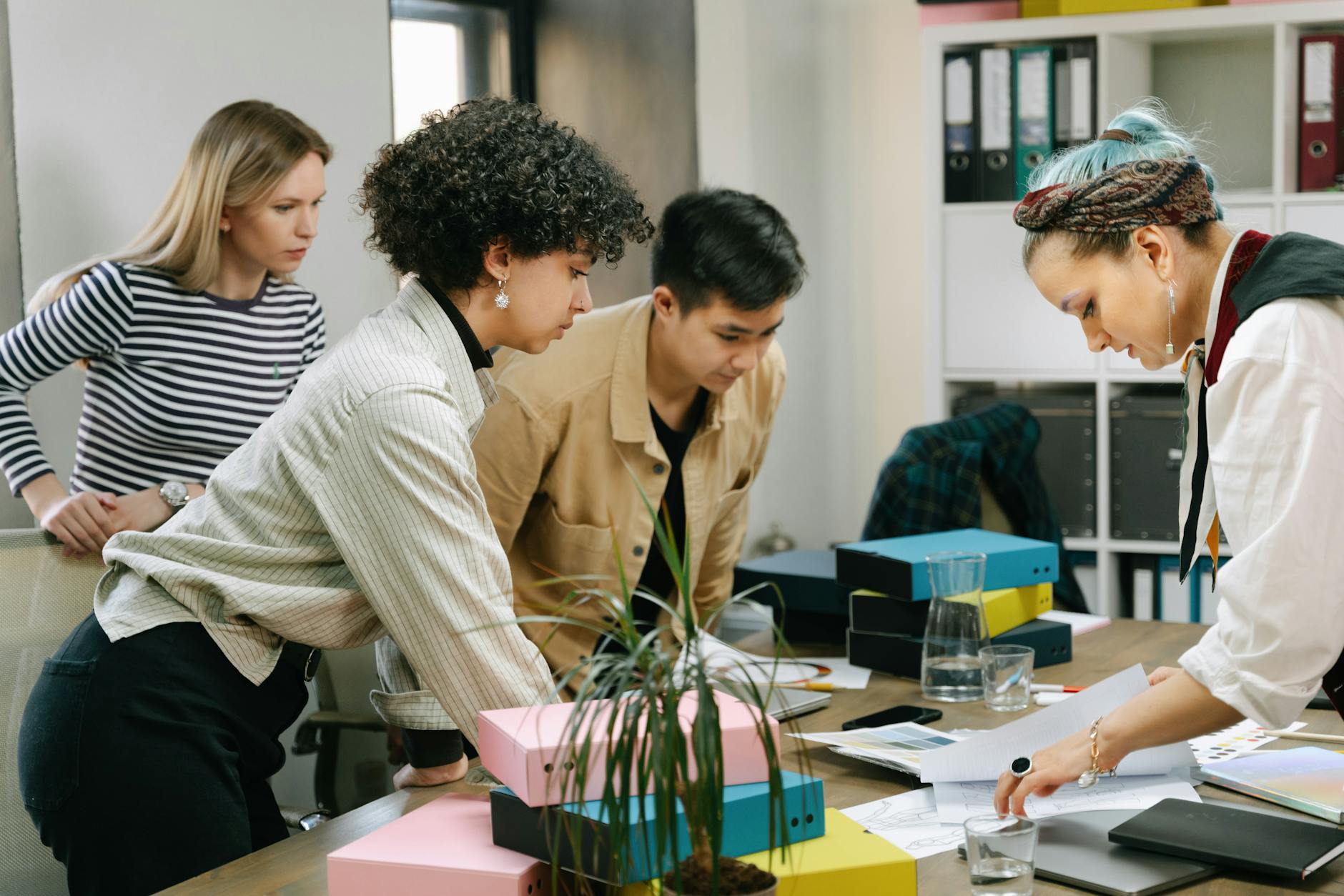 A diverse team of colleagues collaborating on a business project in a modern office setting — UPI Study