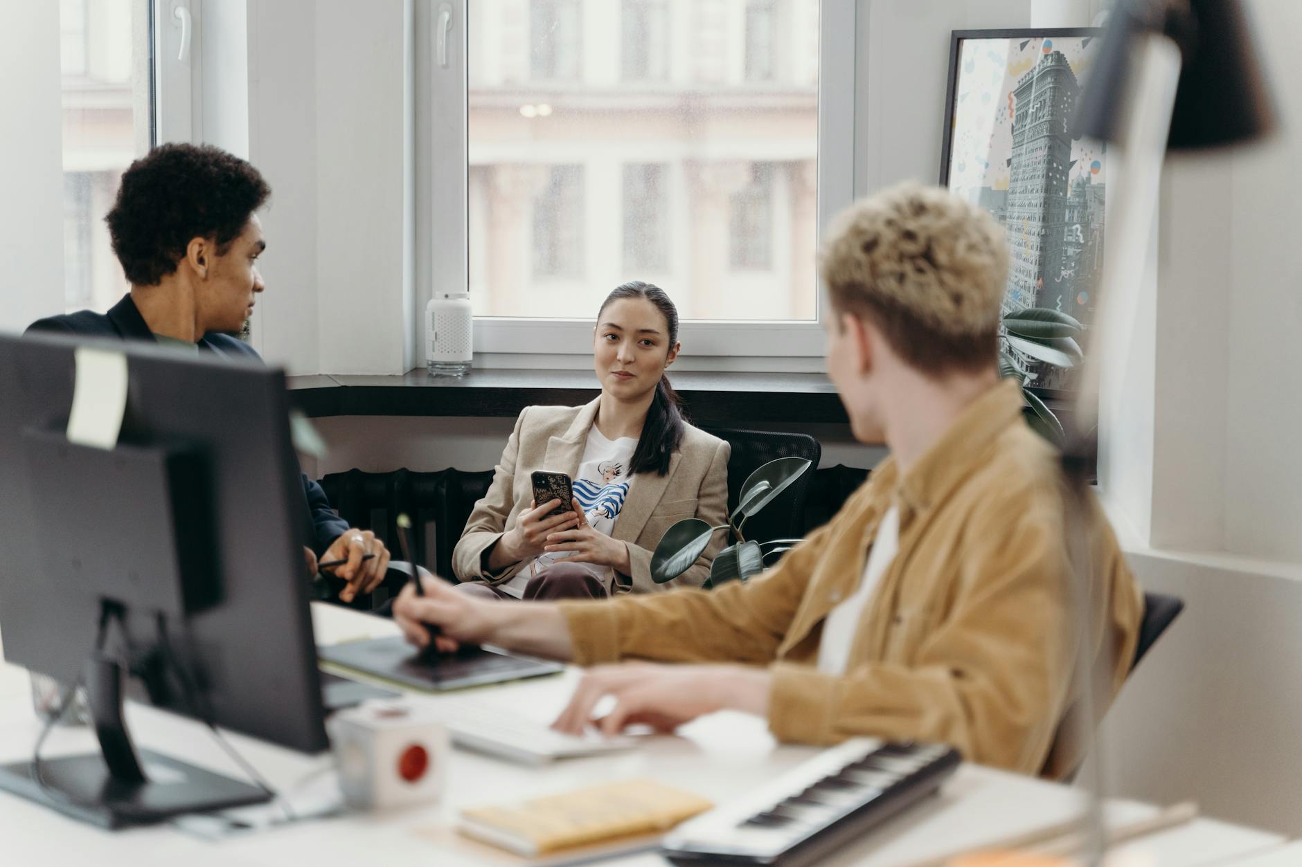 A diverse group of colleagues engaged in a team meeting in a modern office environment — UPI Study