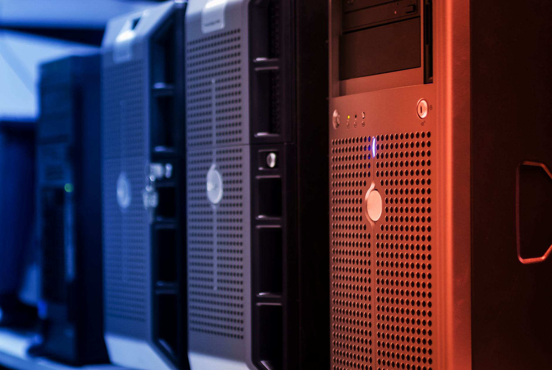 Close-up of tower servers in a data center with blue and red lighting — UPI Study