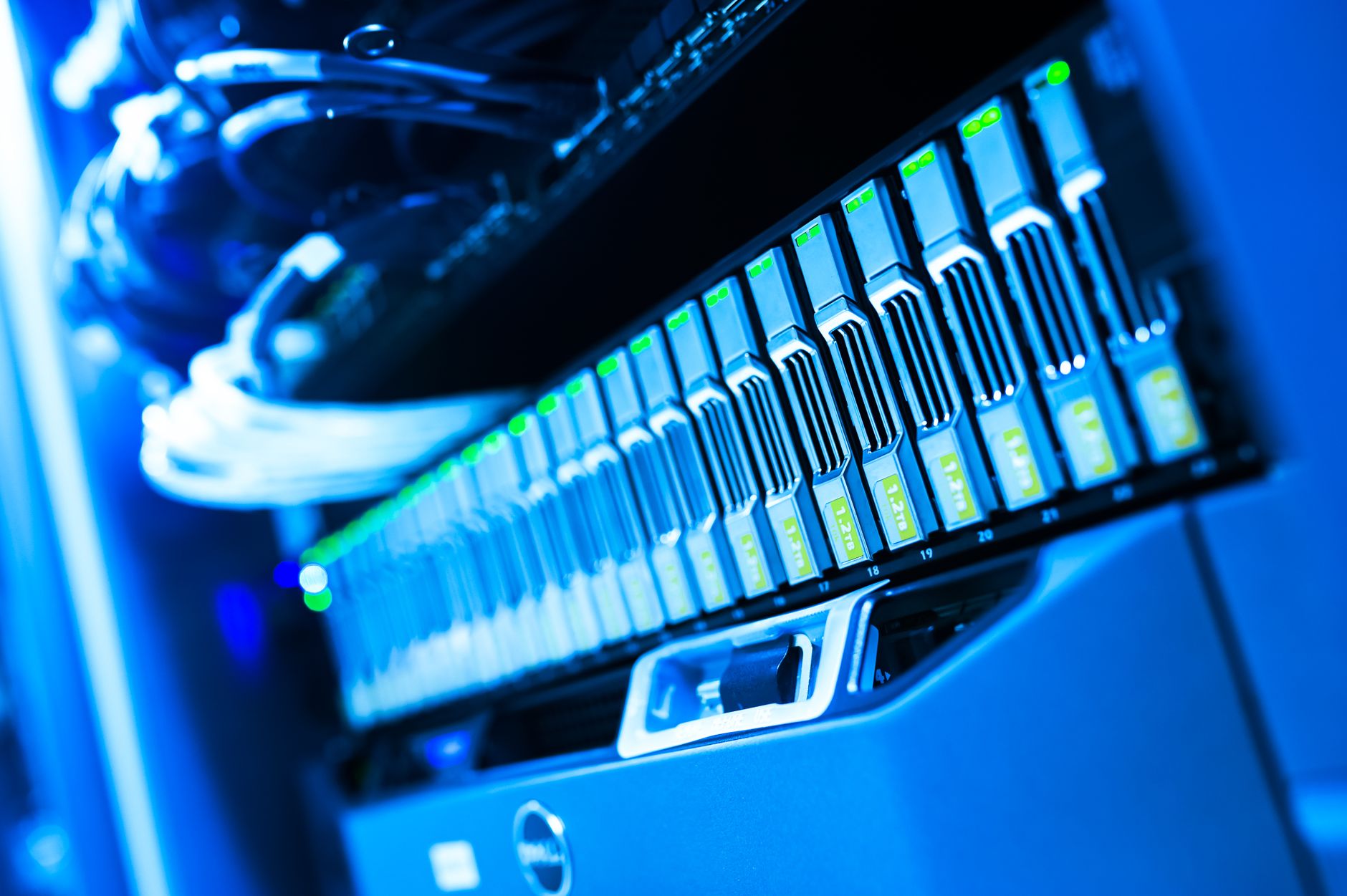 A detailed view of a blue lit computer server rack in a data center showcasing technology and hardware — UPI Study