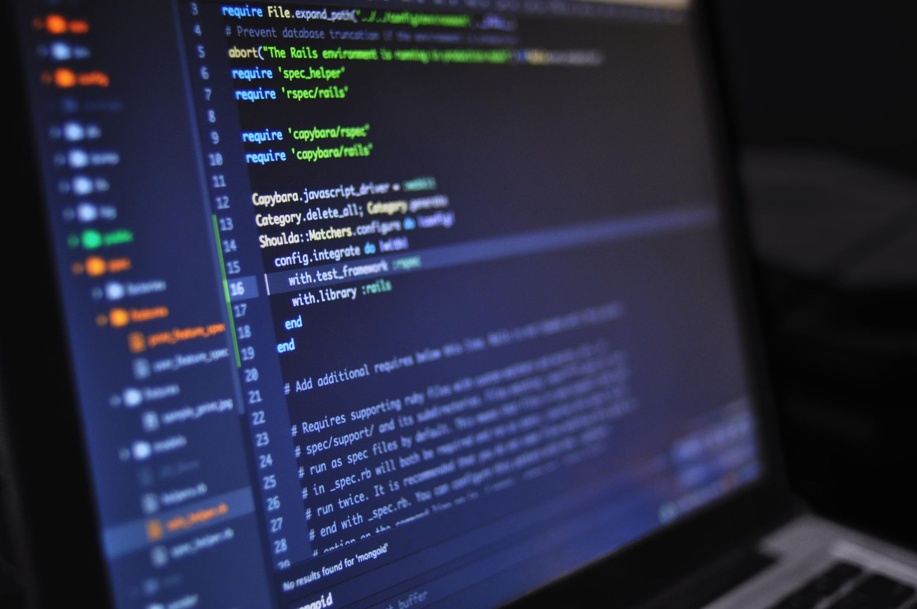 Close-up of a computer screen displaying programming code in a dark environment — UPI Study
