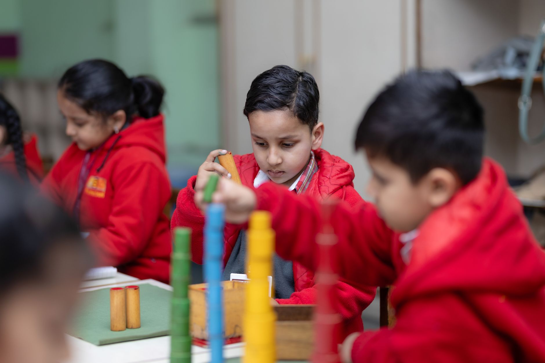 Young children focused on Montessori educational activities, fostering cognitive development — UPI Study