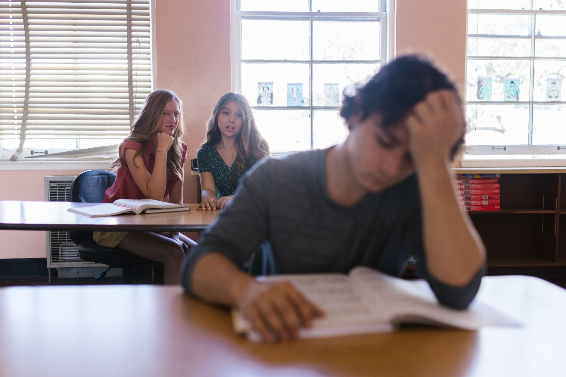 Focused on a teenager feeling bullied in a classroom environment with peers — UPI Study