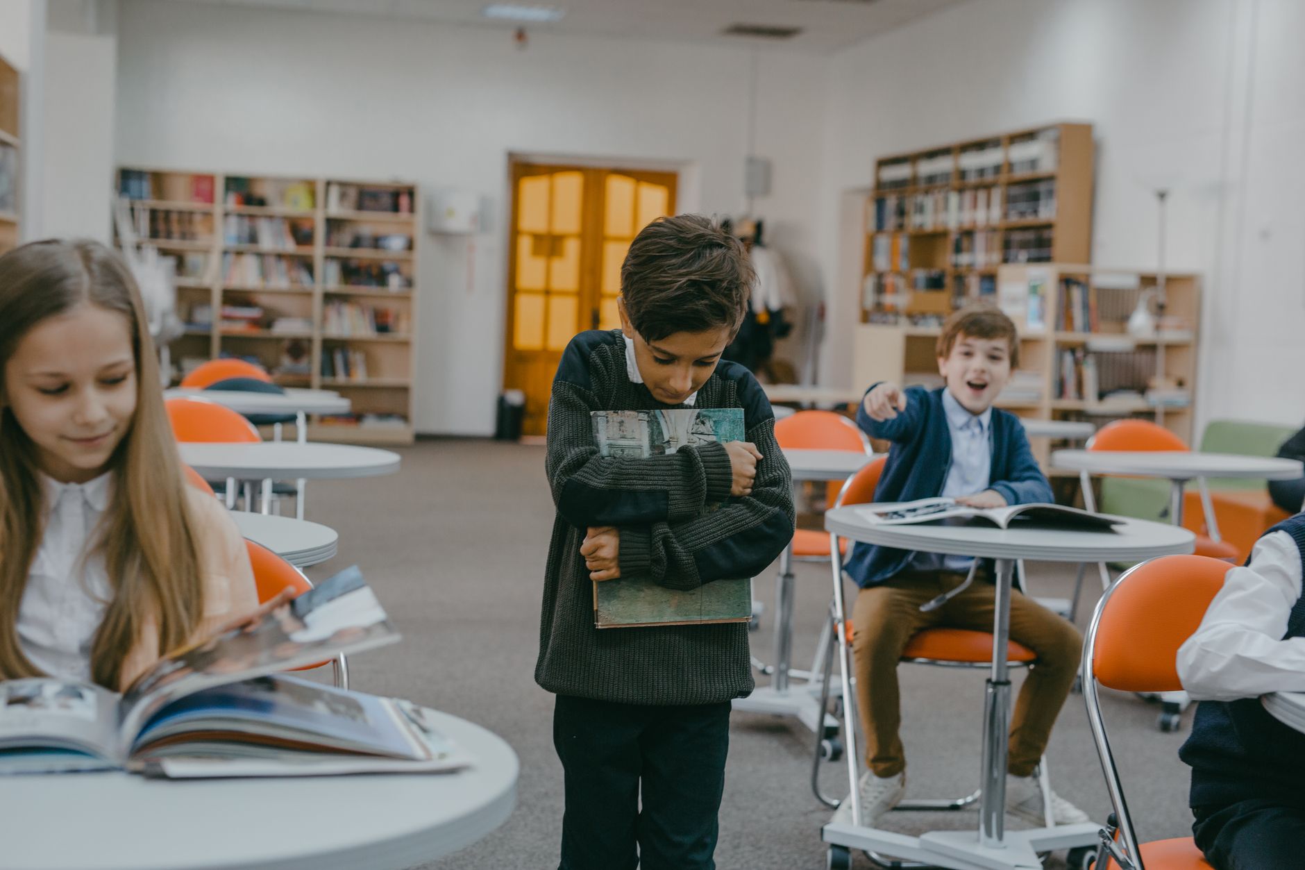A boy being bullied by classmates in a school classroom setting — UPI Study