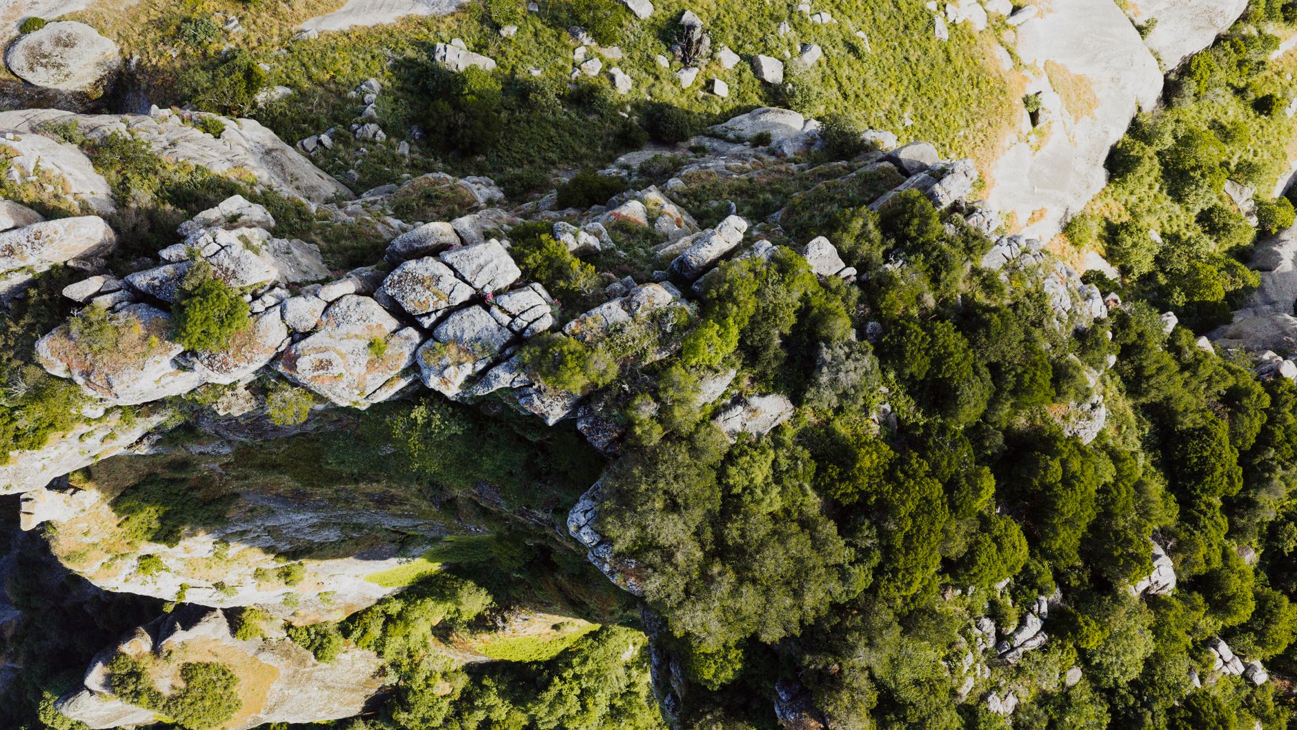 Aerial shot capturing the natural rocky formations and vegetation in Greece, showcasing an intricate landscape — UPI Study