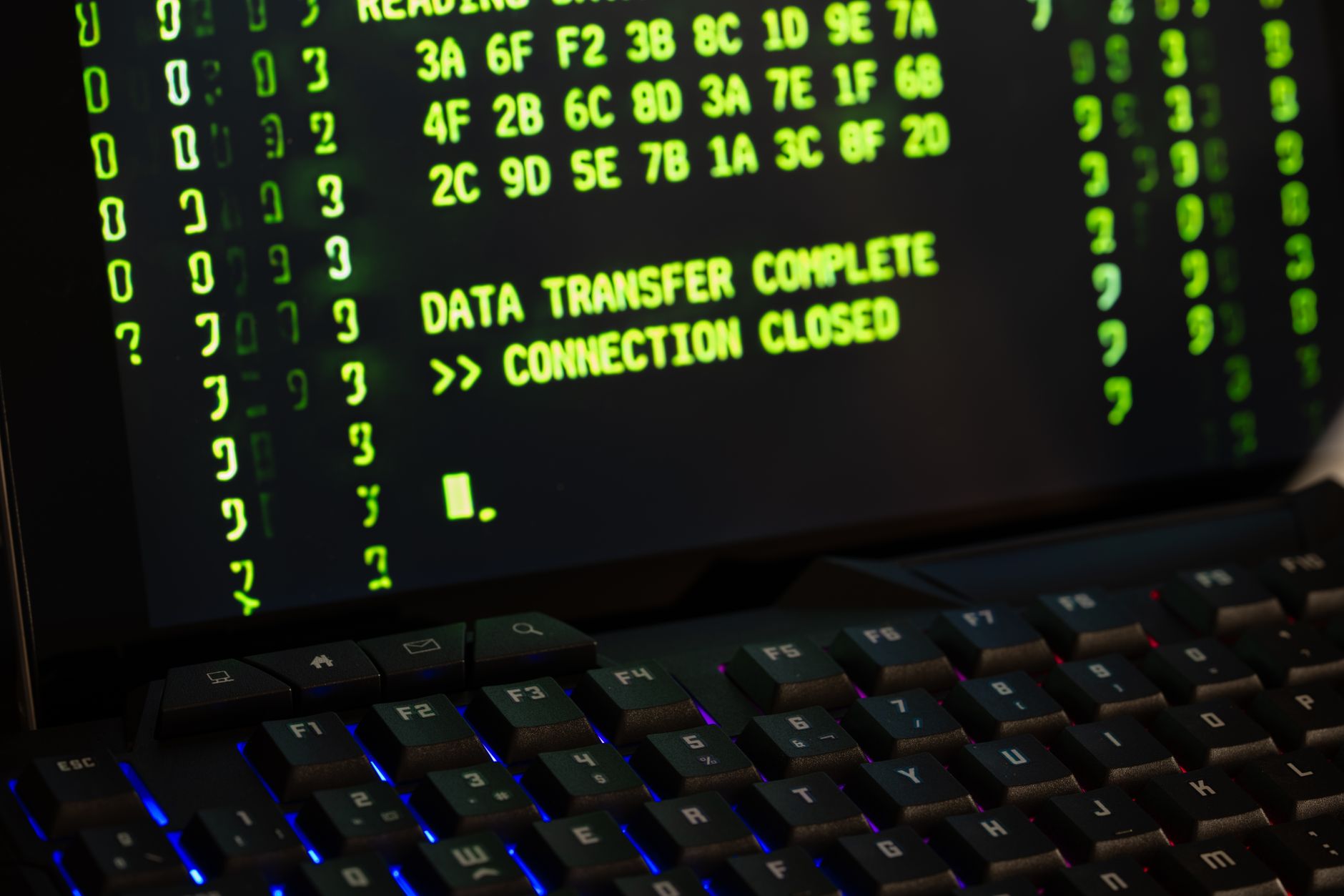 Data transfer complete message displayed on a computer monitor with a keyboard underneath — UPI Study