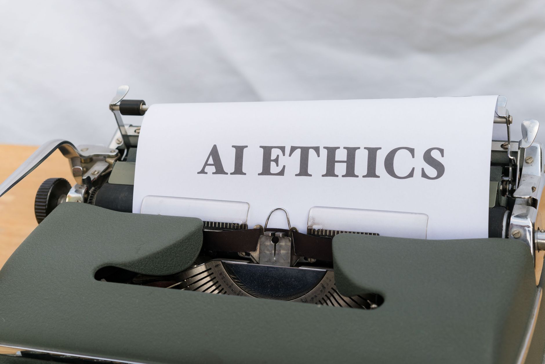 Close-up of vintage typewriter with 'AI ETHICS' typed on paper, emphasizing technology and responsibility — UPI Study
