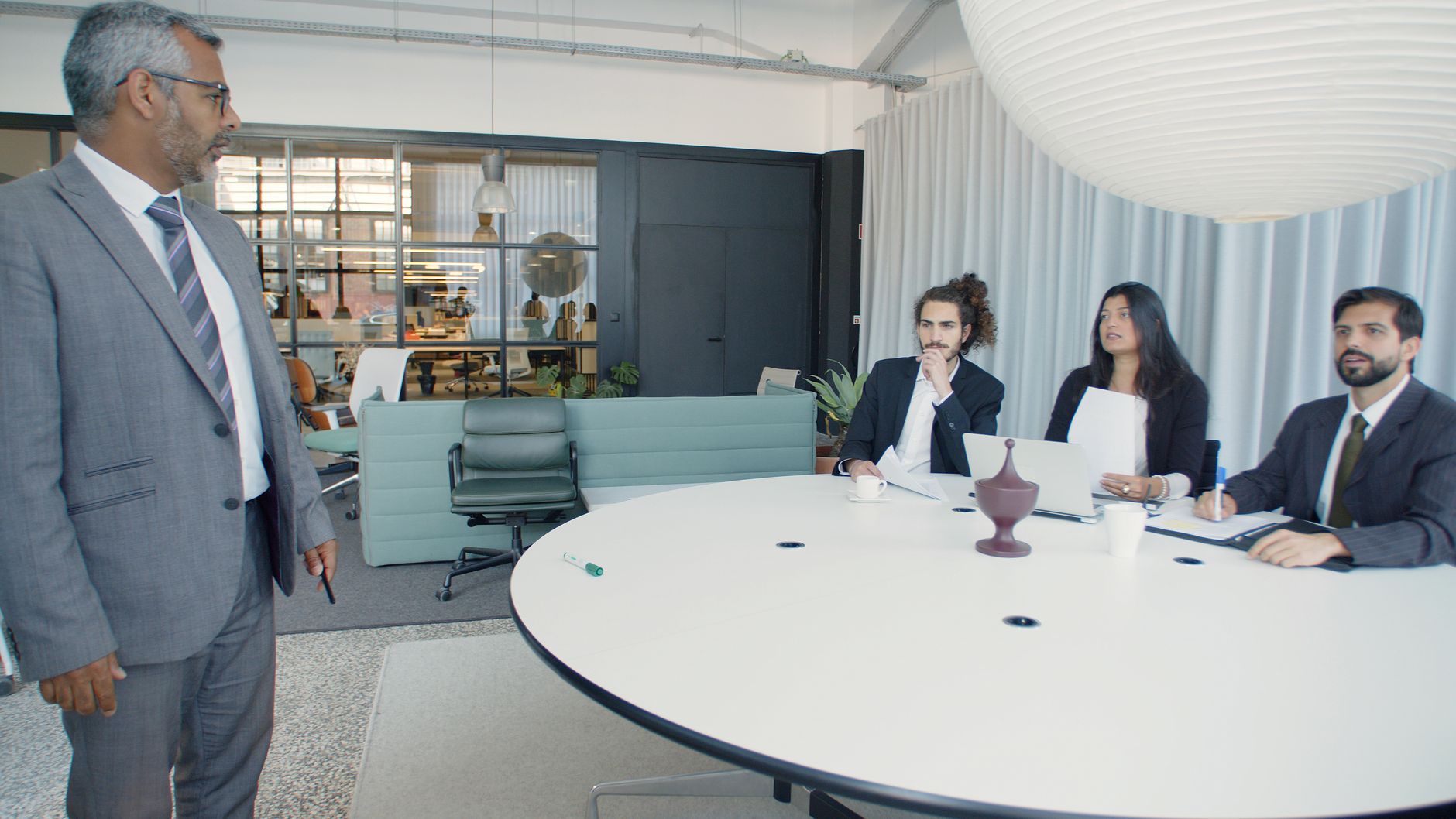 Professional business meeting with executives in a modern conference room — UPI Study