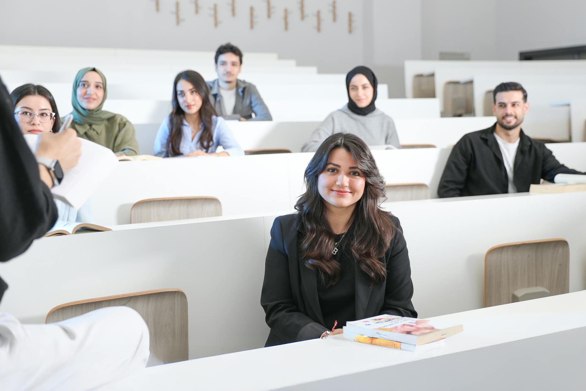 Students listening attentively in a bright university lecture hall — UPI Study