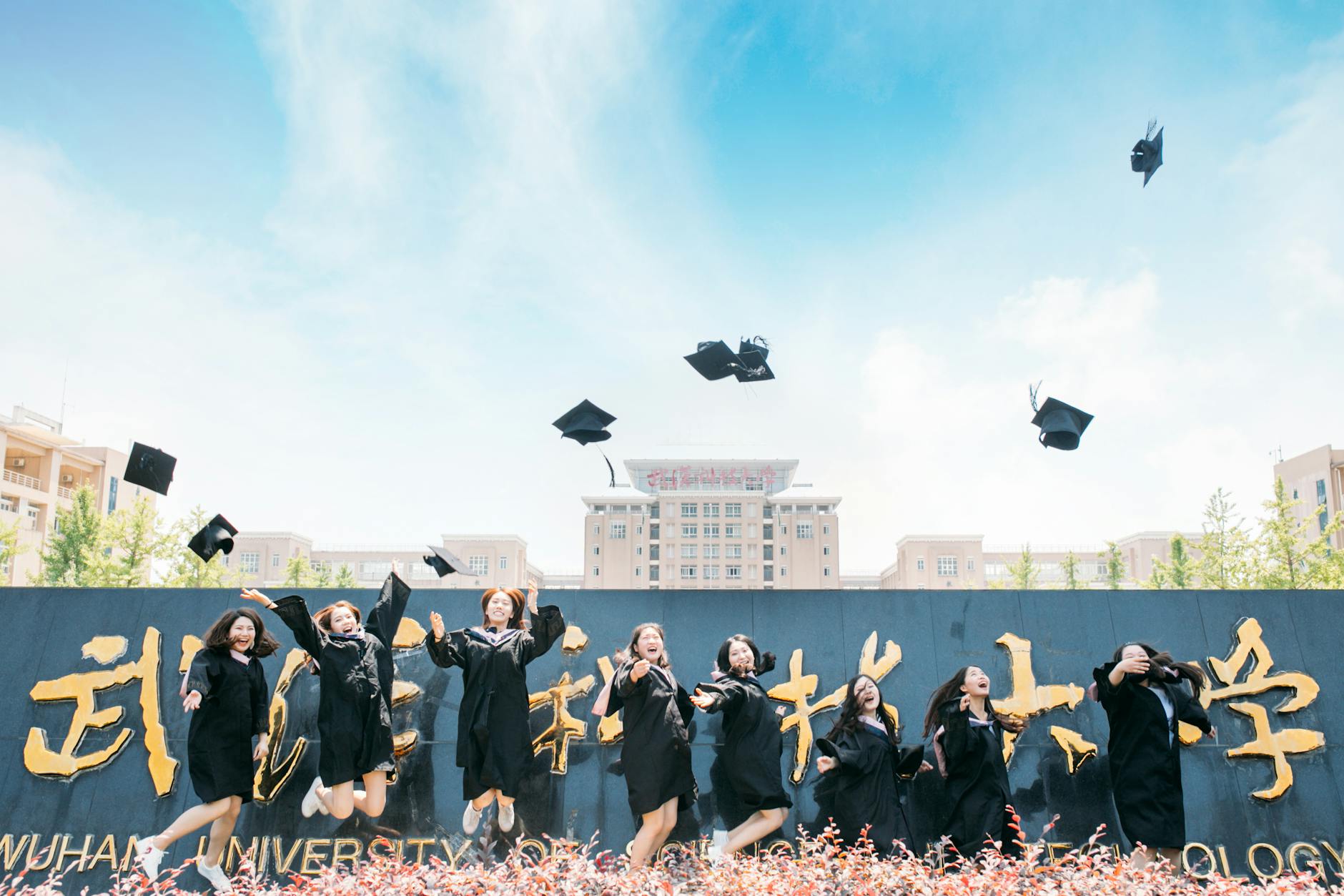 Graduates celebrate their success by tossing caps at Wuhan University, China — UPI Study