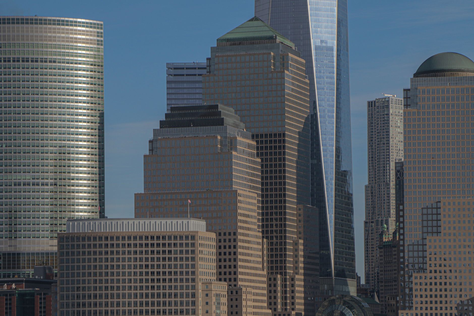 Stunning view of New York City high-rises, including the One World Trade Center, against a clear blue sky — UPI Study