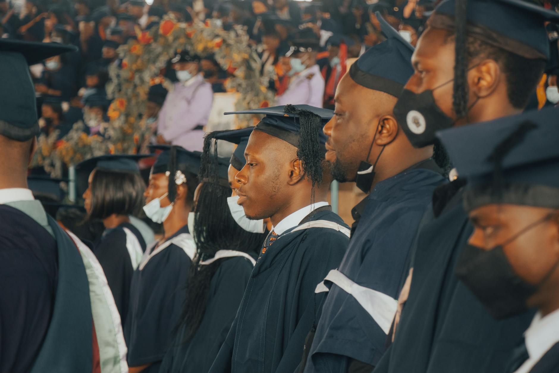 Graduates in Nigeria celebrate their academic achievements in academic regalia — UPI Study