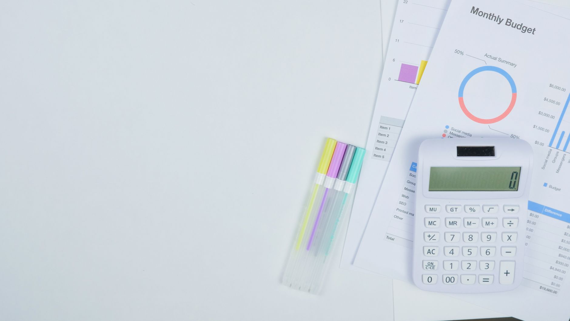Minimalist office desk with a calculator, budget planning documents, and colorful pens — UPI Study