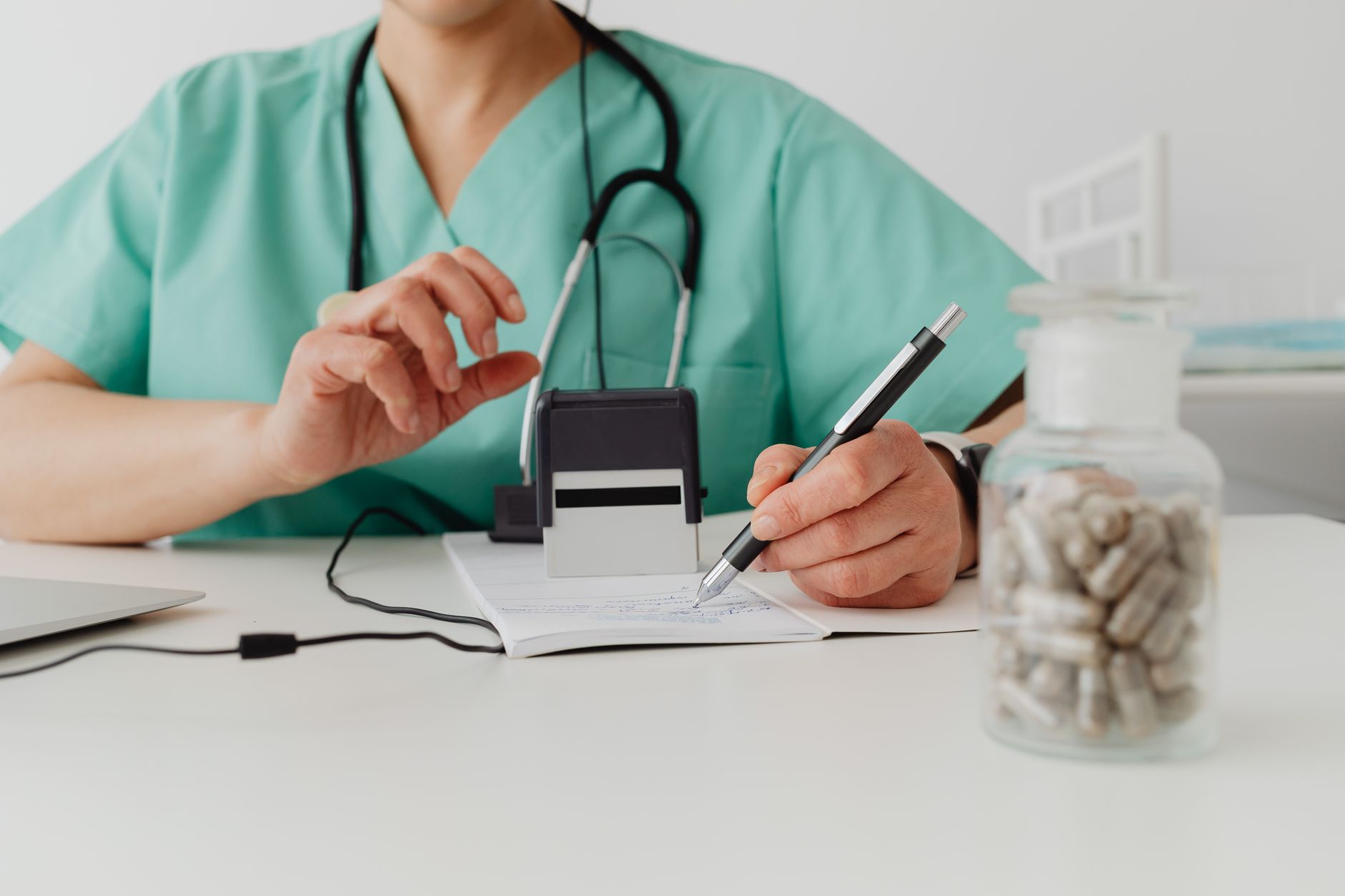 A medical professional writing a prescription in a clinical setting — UPI Study