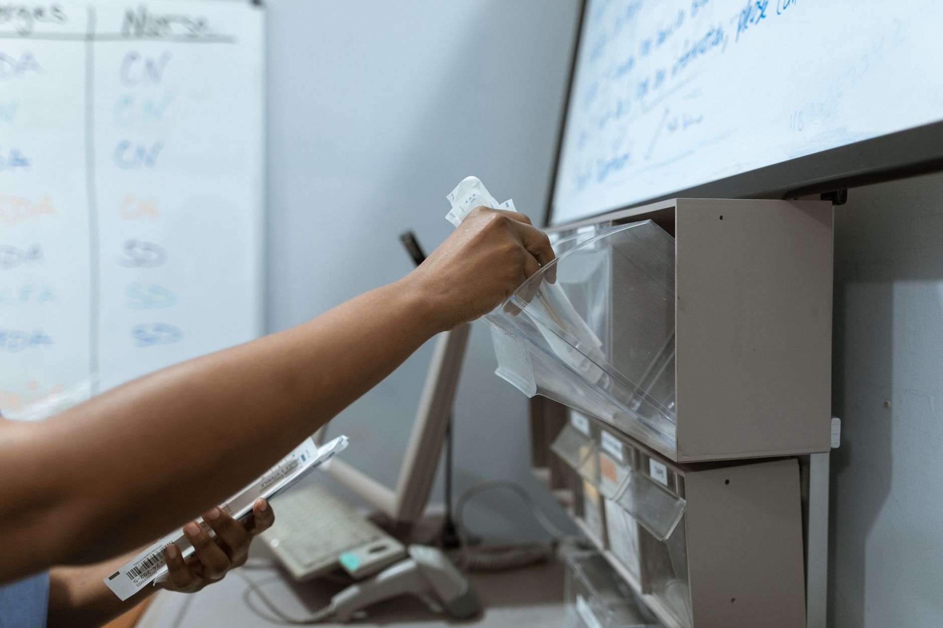 A healthcare worker organizing syringes in a clinic setting, demonstrating medical precision — UPI Study