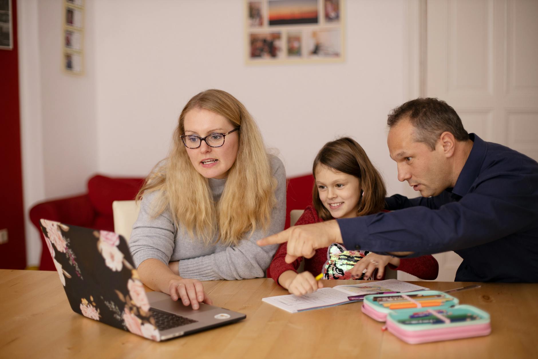 A family learning together with a laptop at home, emphasizing collaboration and education — UPI Study