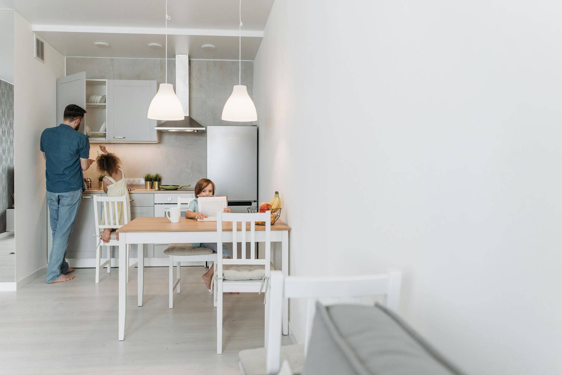 Father and children in a modern kitchen. A warm family moment captured during the day — UPI Study