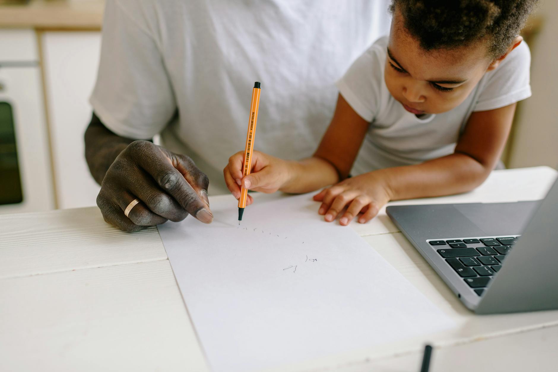 Father and son engage in a creative drawing session at home, fostering learning and connection — UPI Study