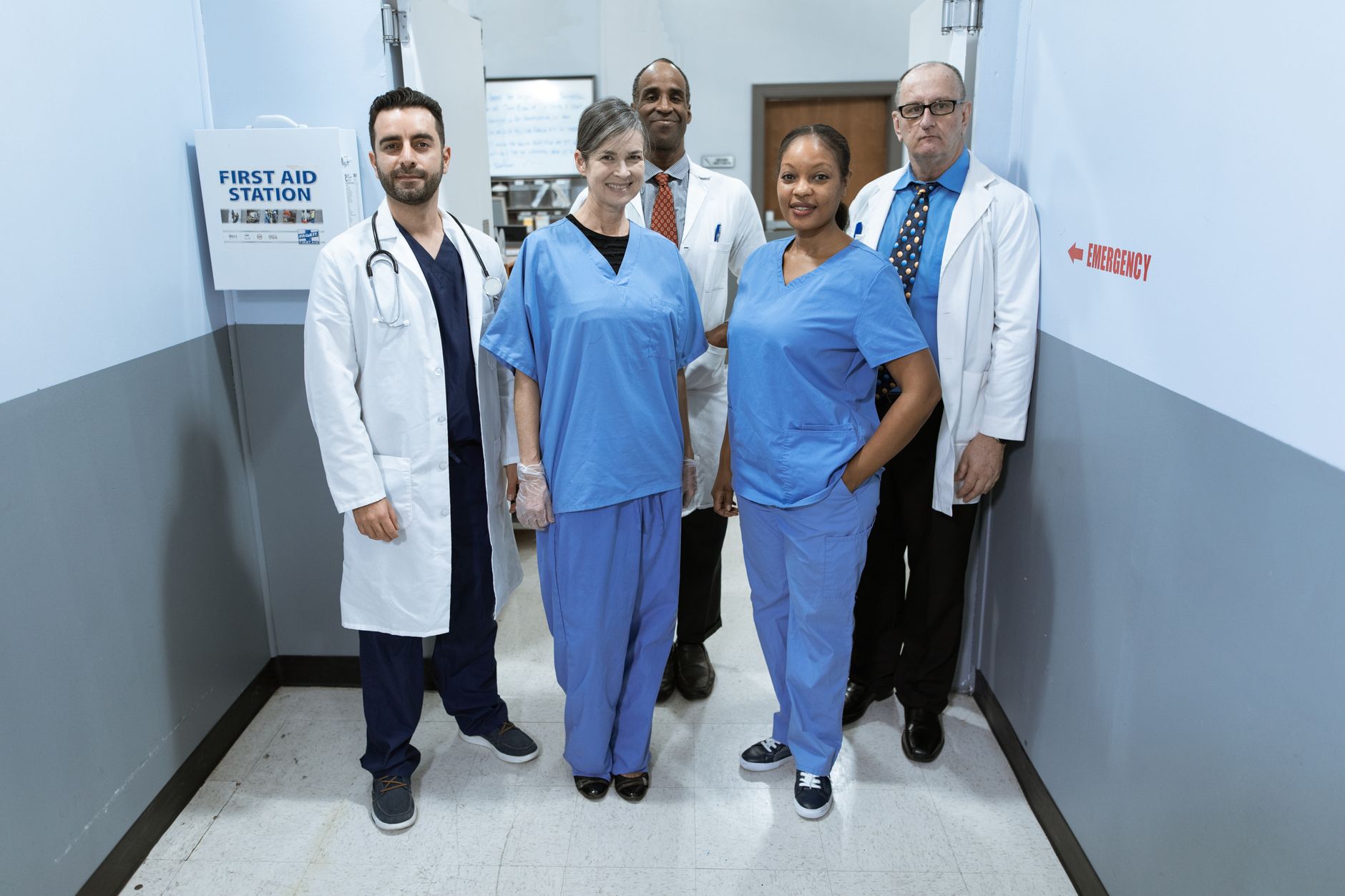 Group of diverse healthcare professionals smiling in a hospital hallway — UPI Study