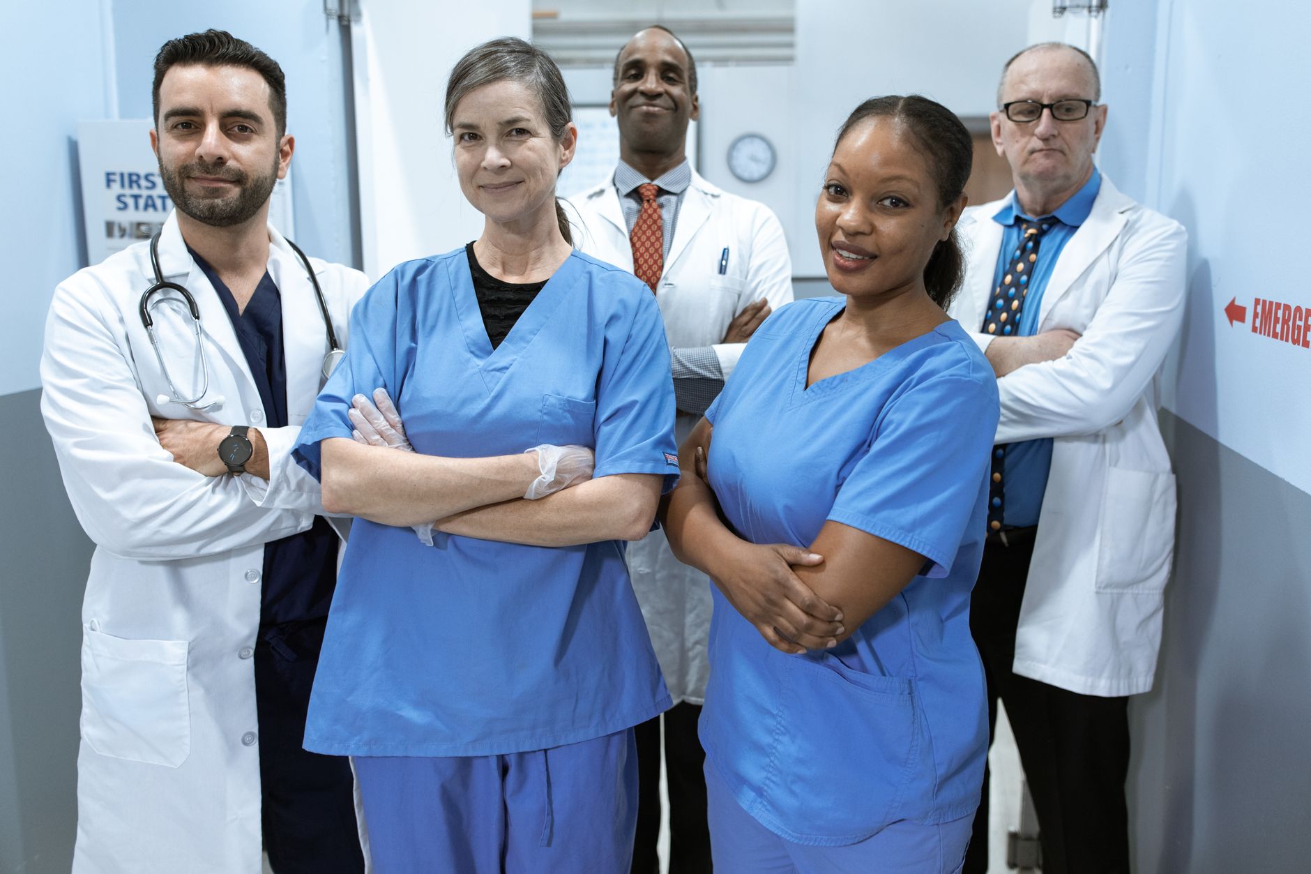 A diverse team of doctors and nurses smiling confidently in a hospital setting — UPI Study