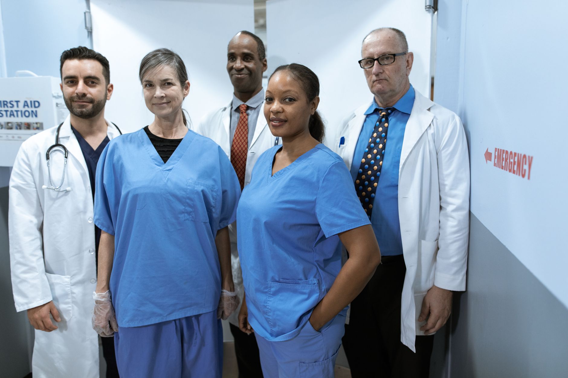 A diverse group of healthcare professionals in hospital uniforms, showcasing teamwork and diversity — UPI Study