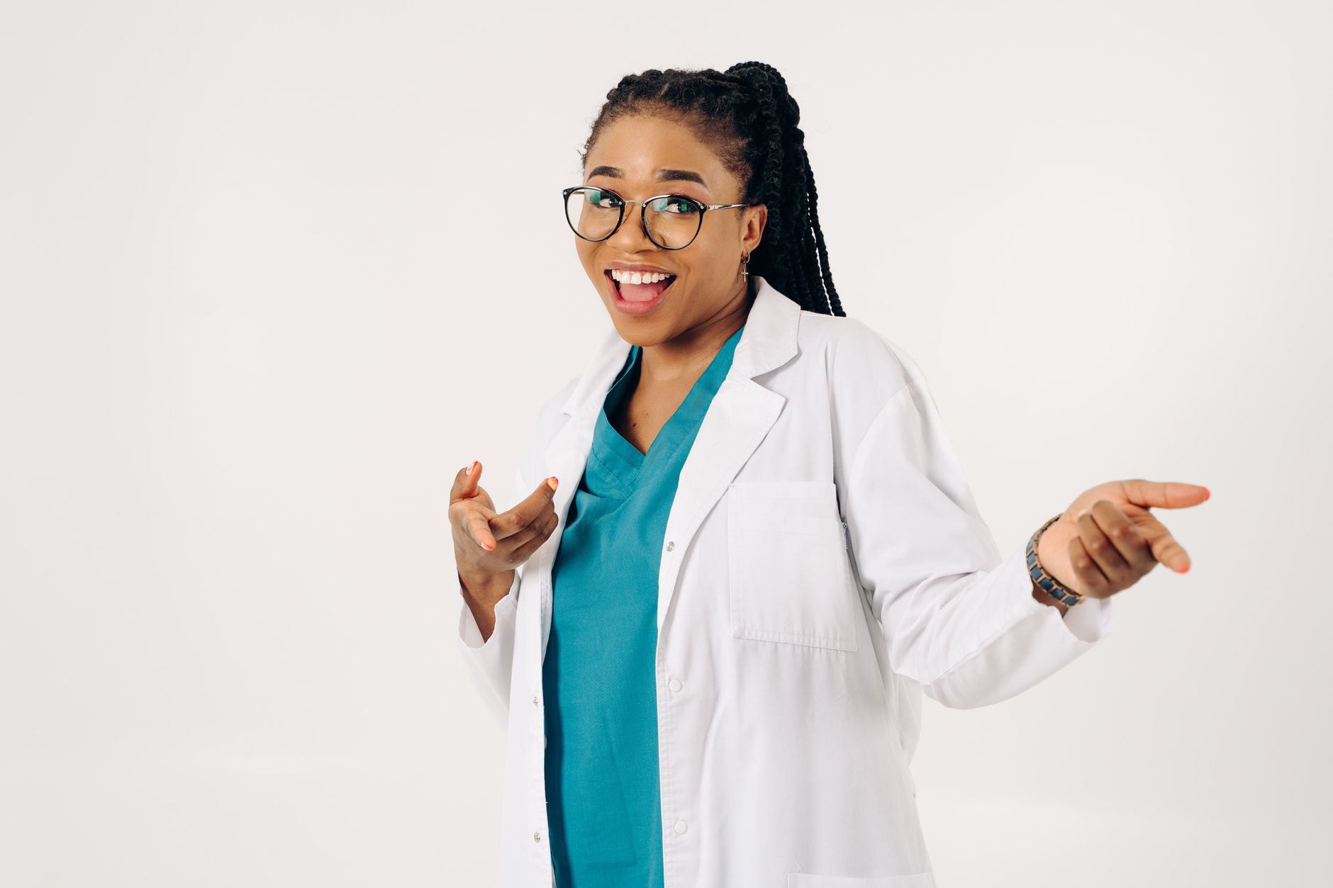 Smiling female doctor pointing in a cheerful pose on a white background — UPI Study