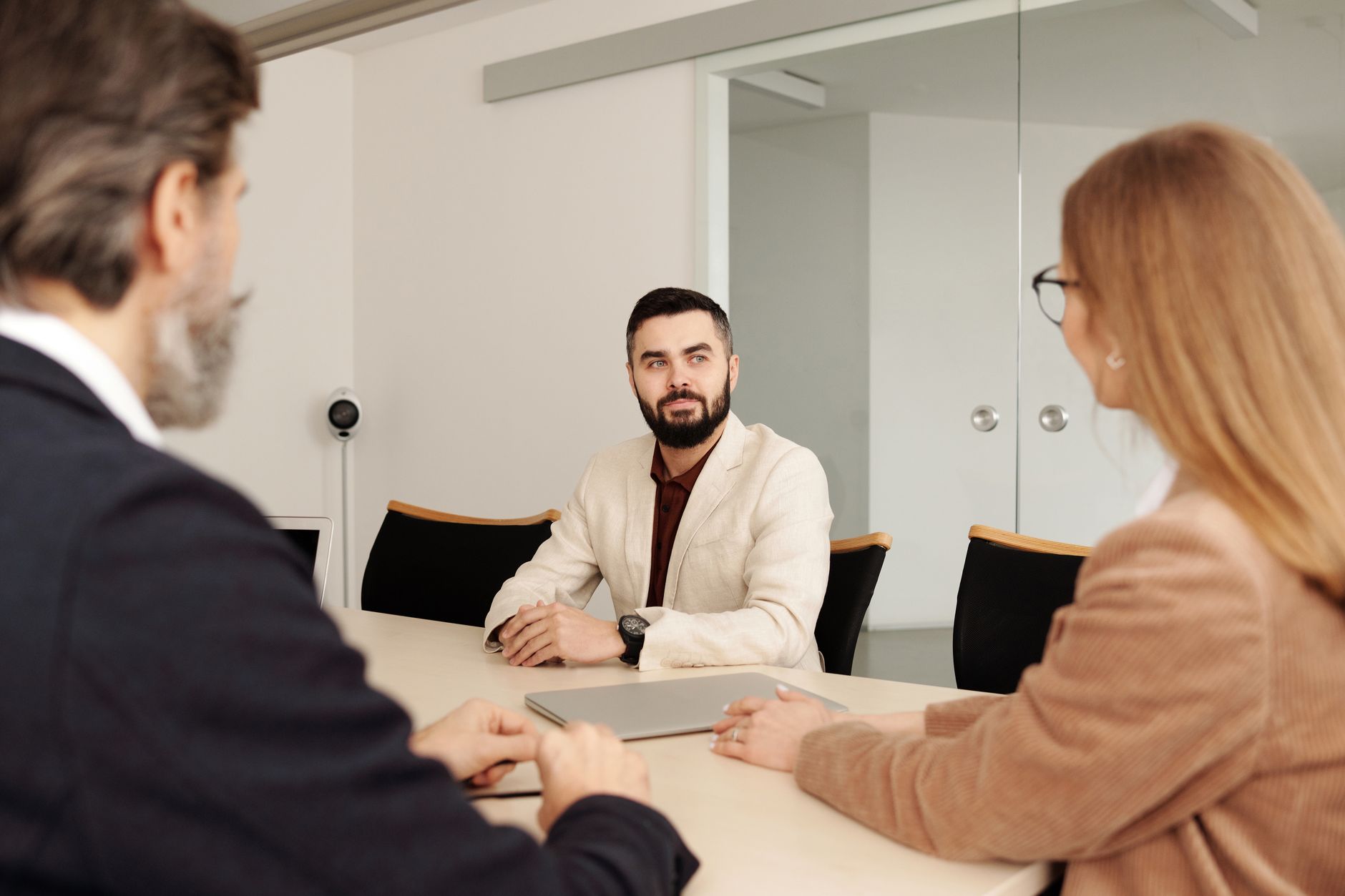 Professional business meeting with diverse team members in an office setting — UPI Study